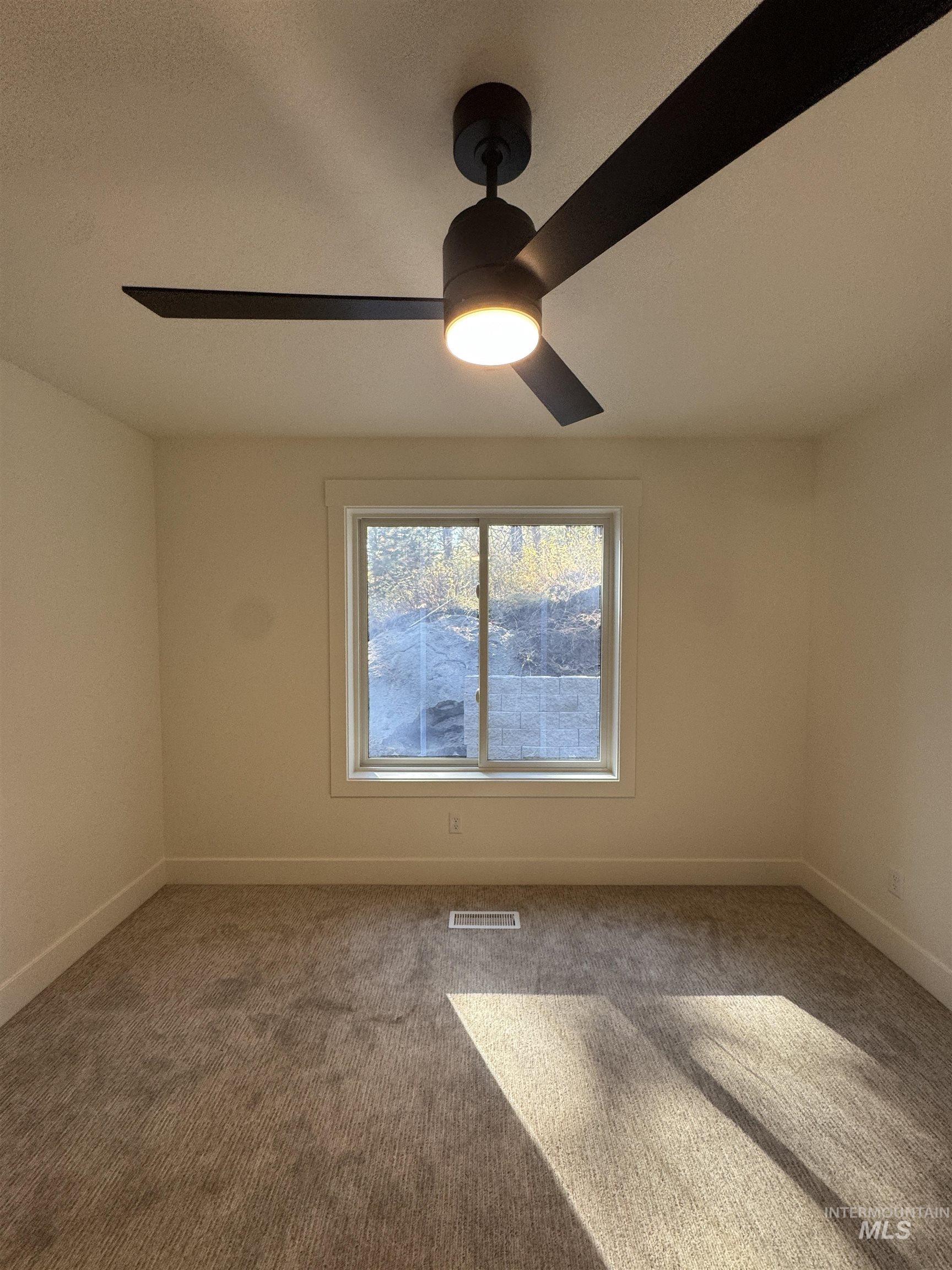 Unfurnished room with carpet and baseboards