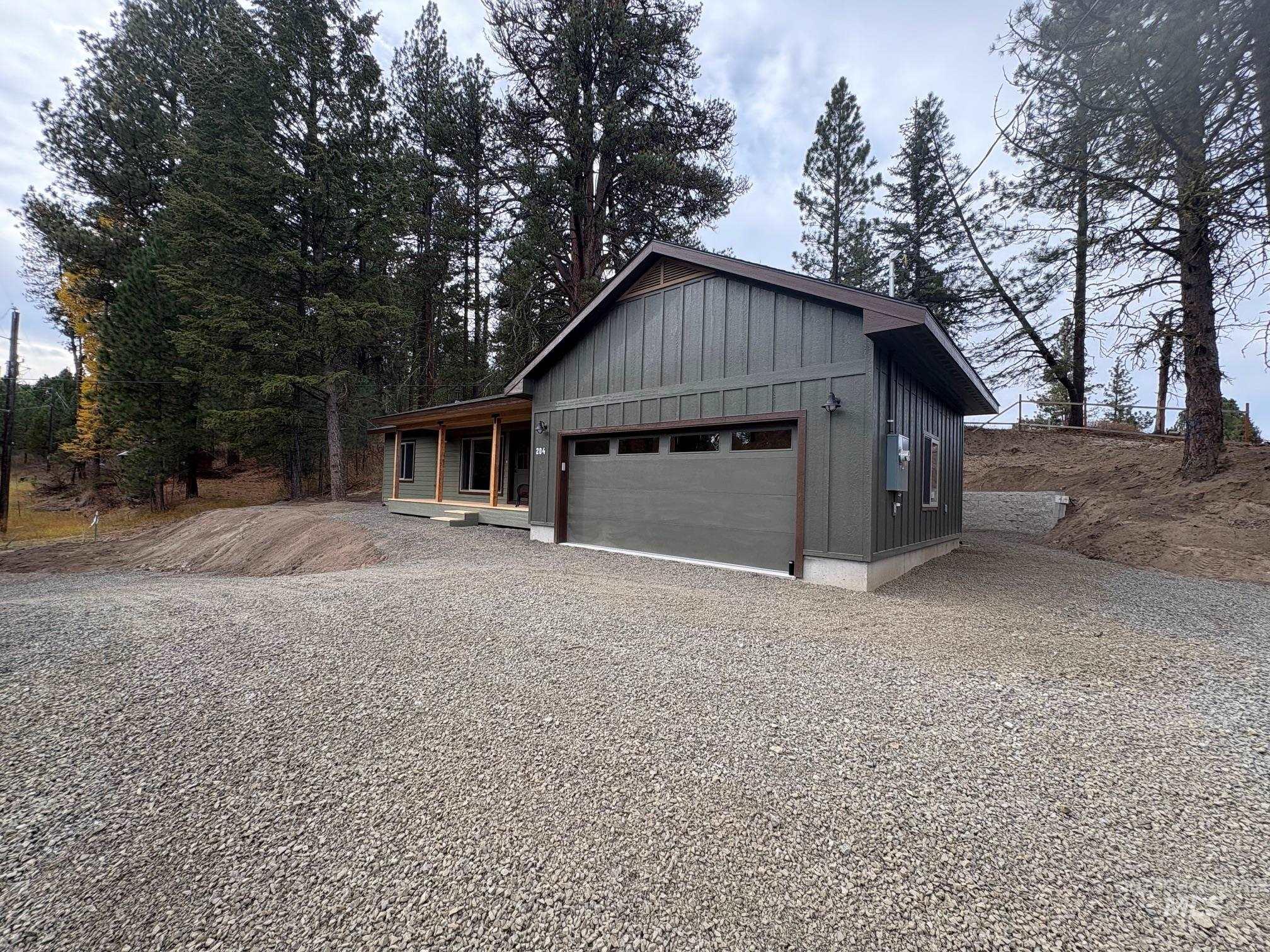 Garage featuring gravel driveway