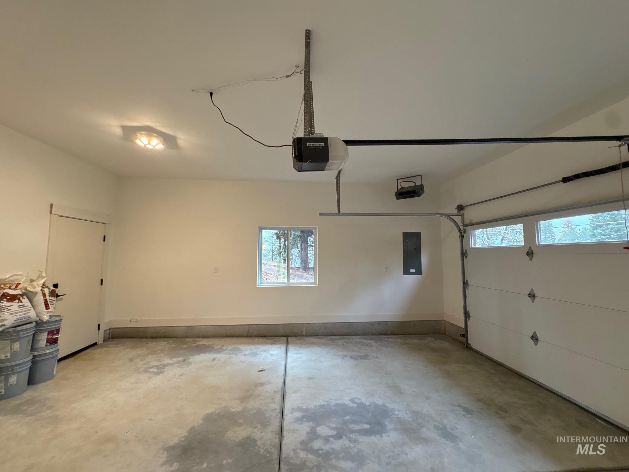 Garage with electric panel and a garage door opener