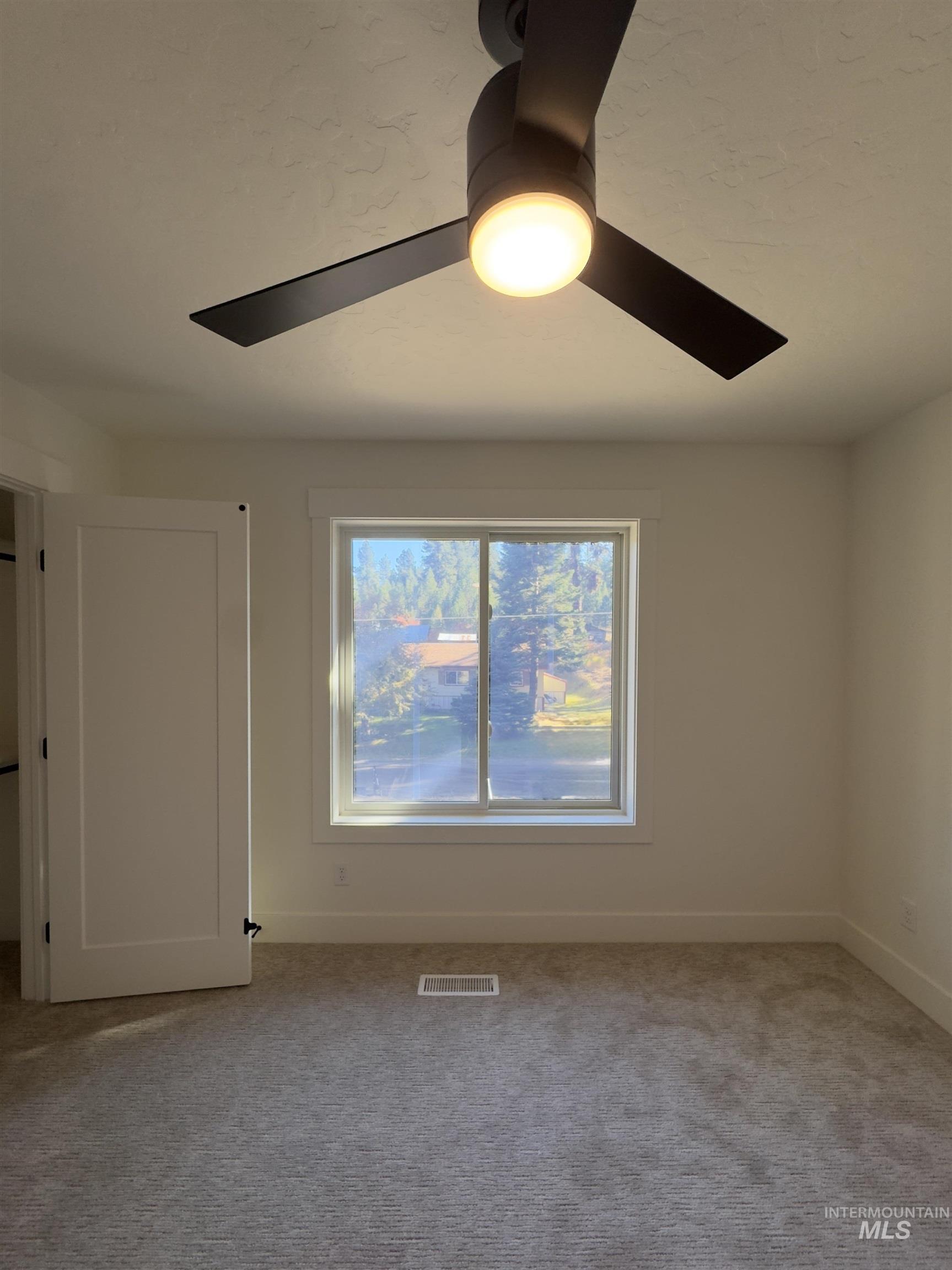 Unfurnished room featuring carpet flooring and baseboards