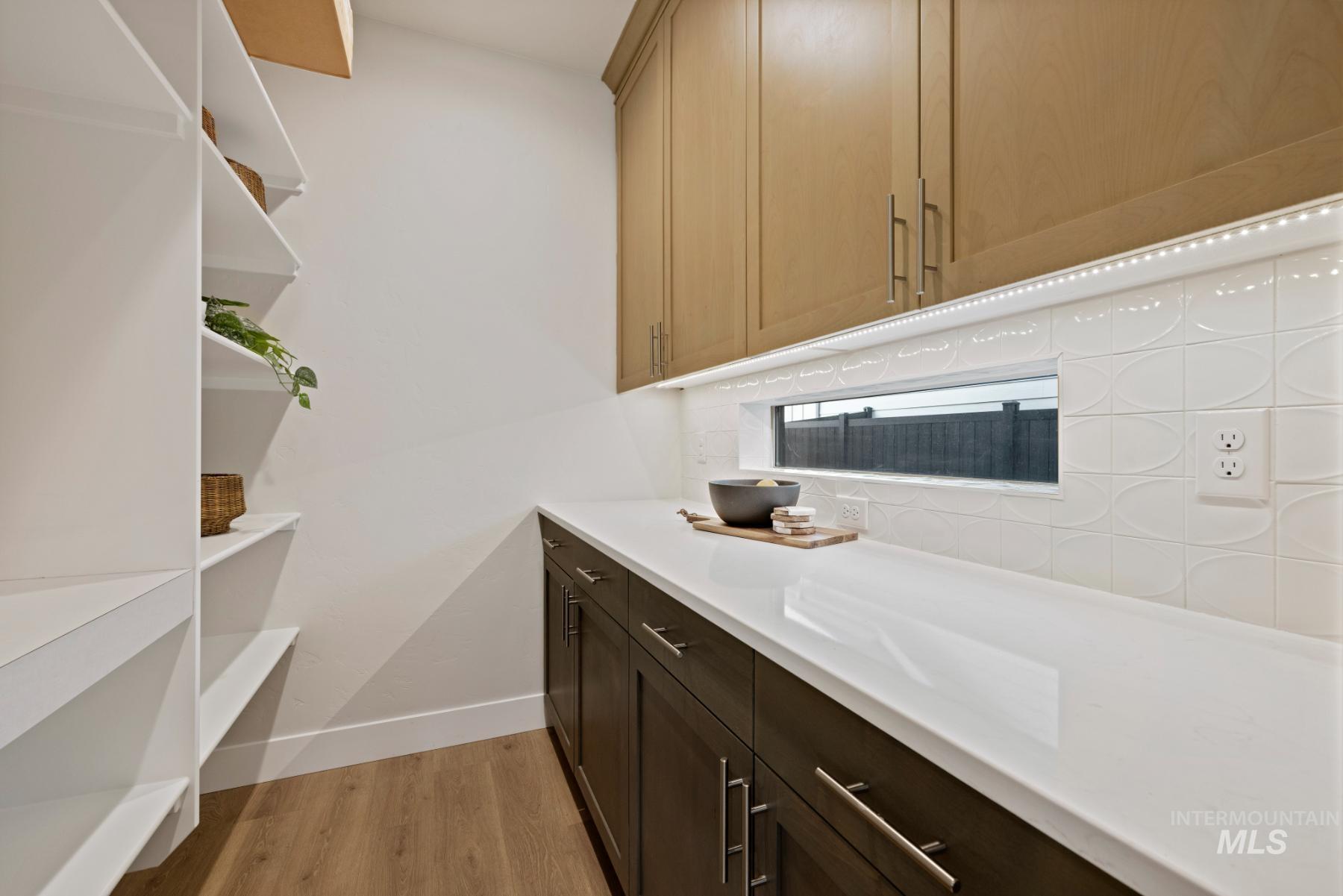 Laundry room with light wood-style floors and baseboards
