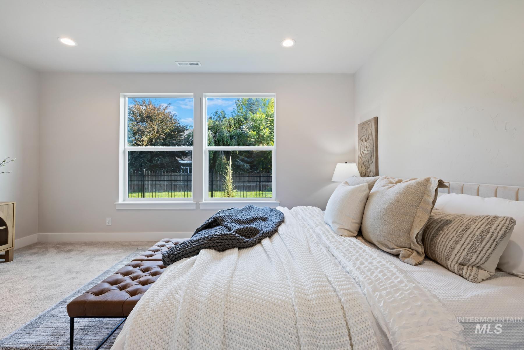 Carpeted bedroom with baseboards and recessed lighting