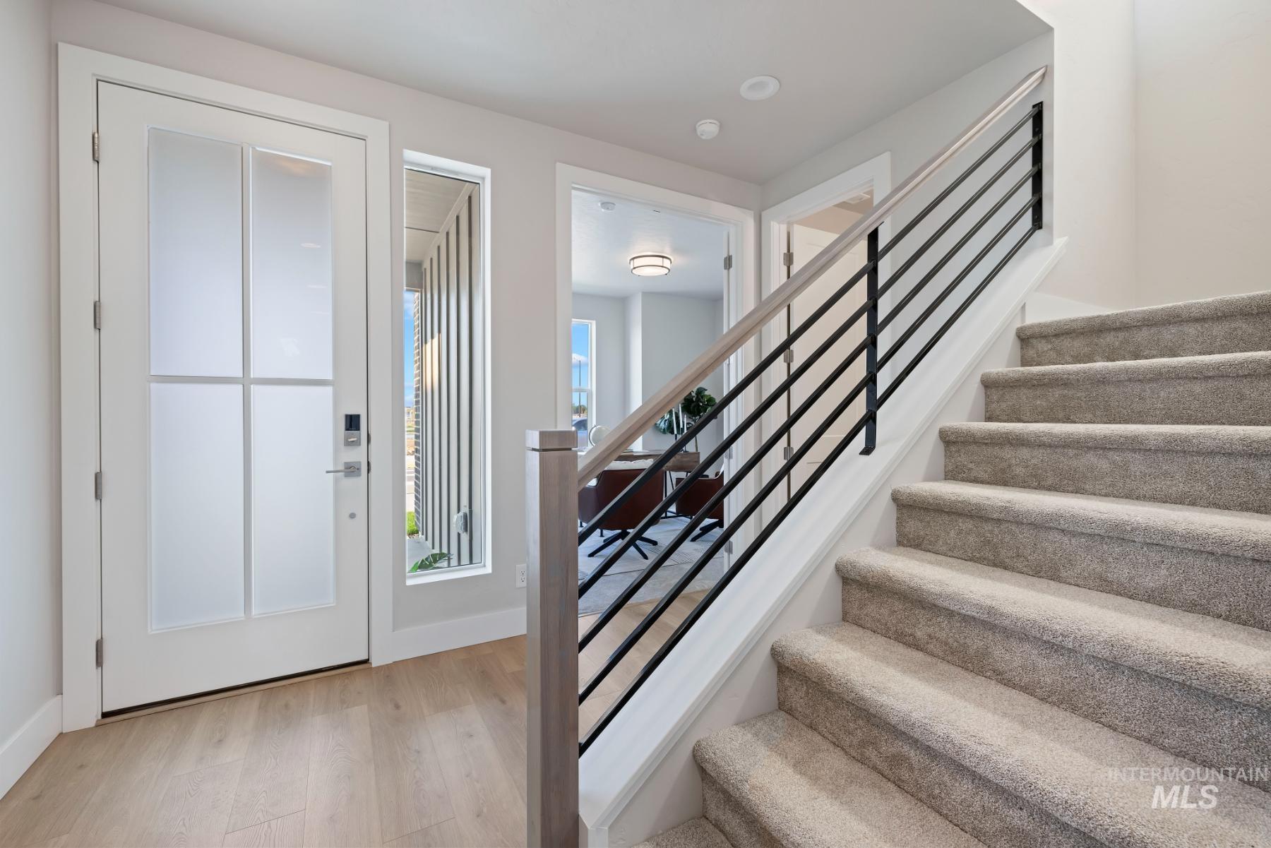 Entrance foyer with stairs and light wood finished floors
