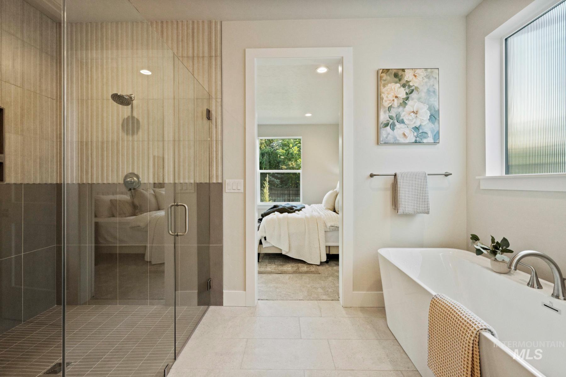 Ensuite bathroom with a stall shower, a freestanding tub, tile patterned floors, and recessed lighting