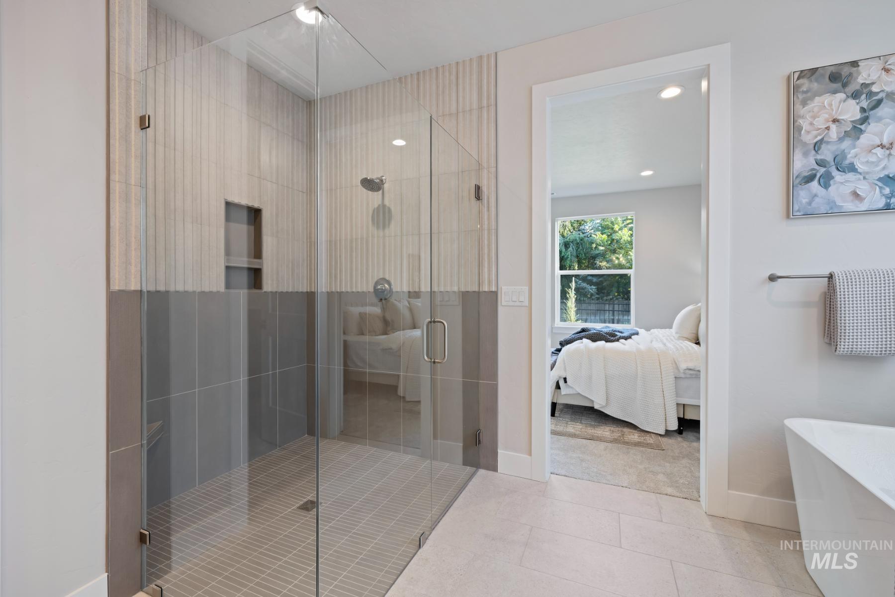 Full bath featuring ensuite bathroom, a stall shower, tile patterned flooring, recessed lighting, and a freestanding tub