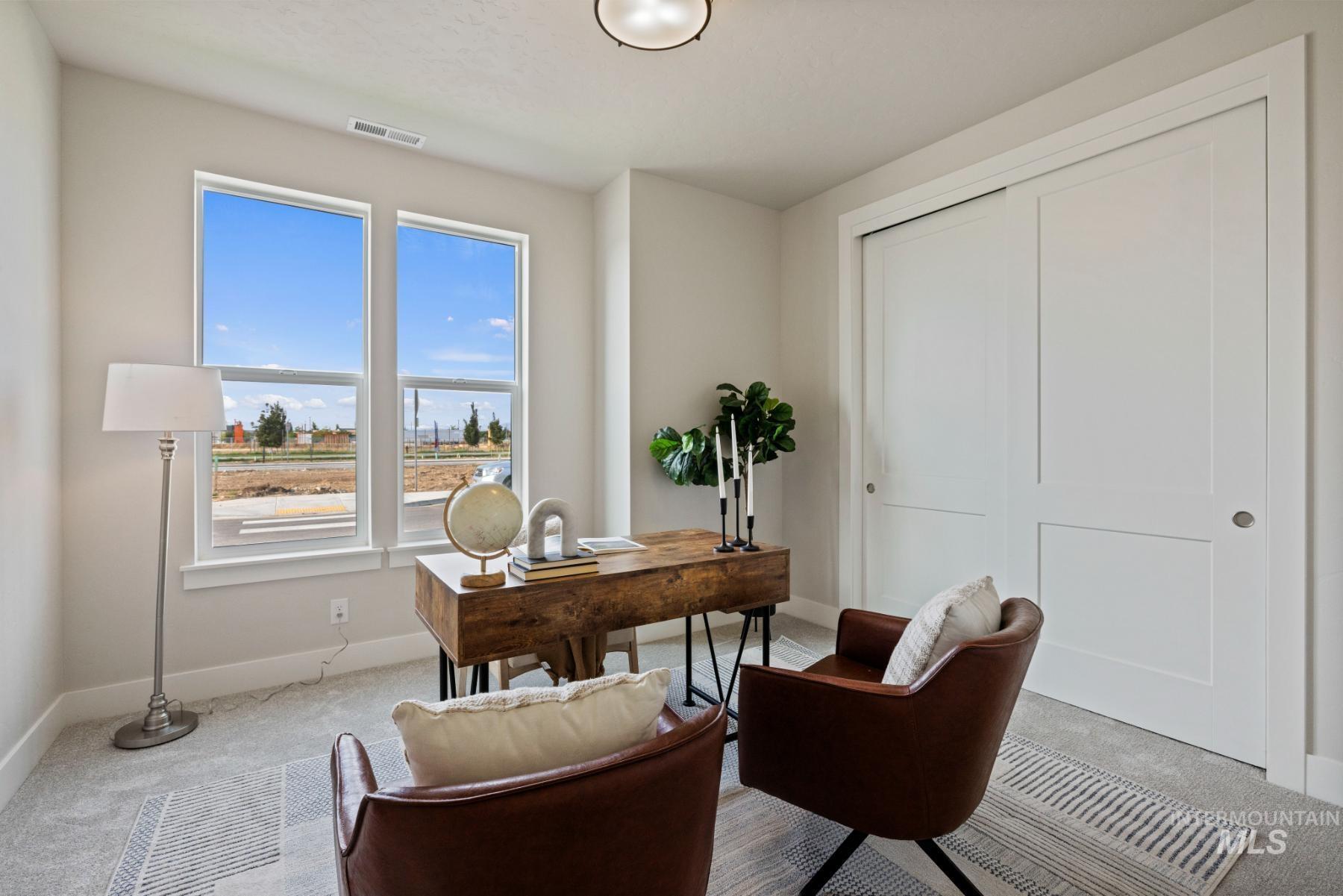 Carpeted office space with baseboards