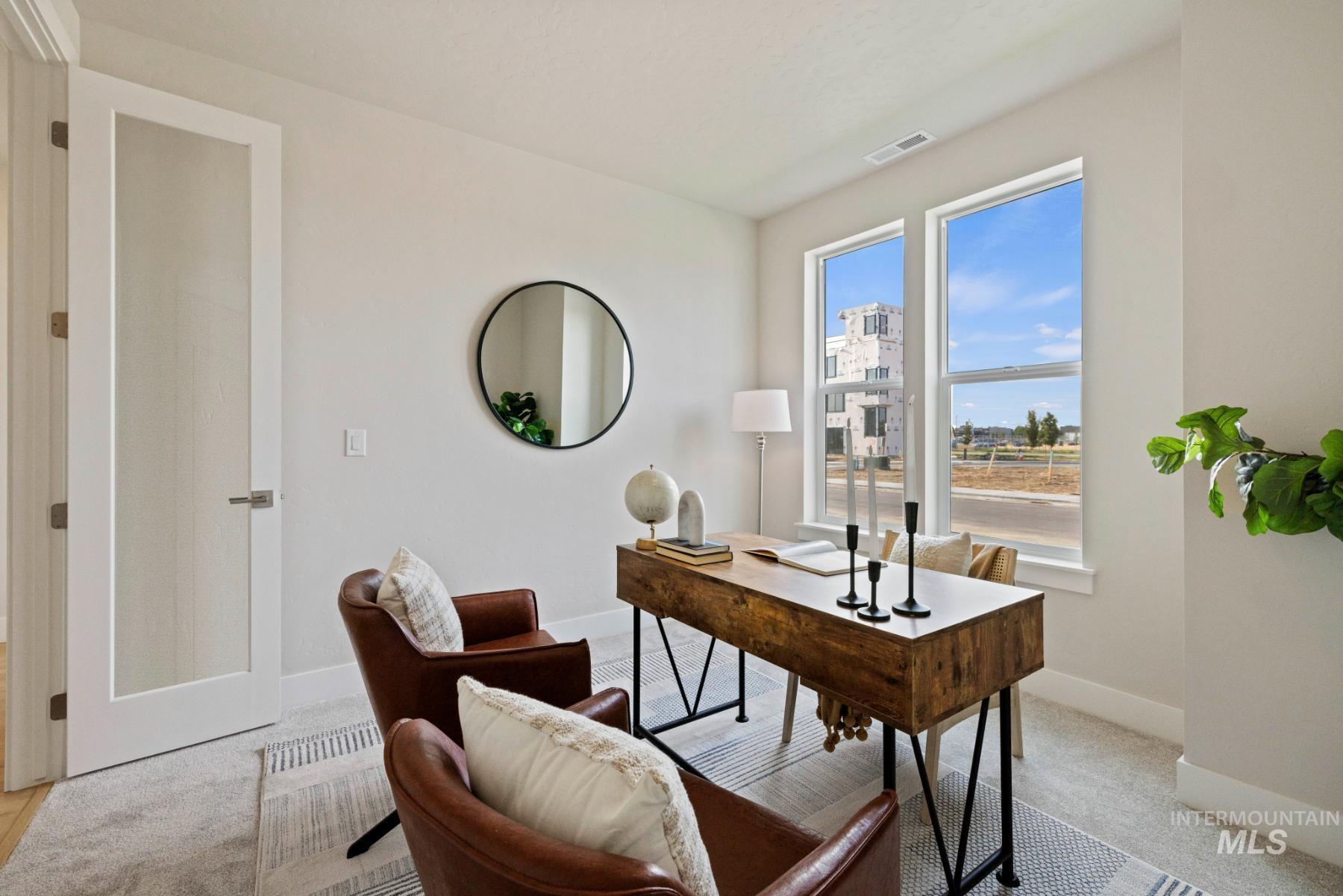 Home office with baseboards and light carpet