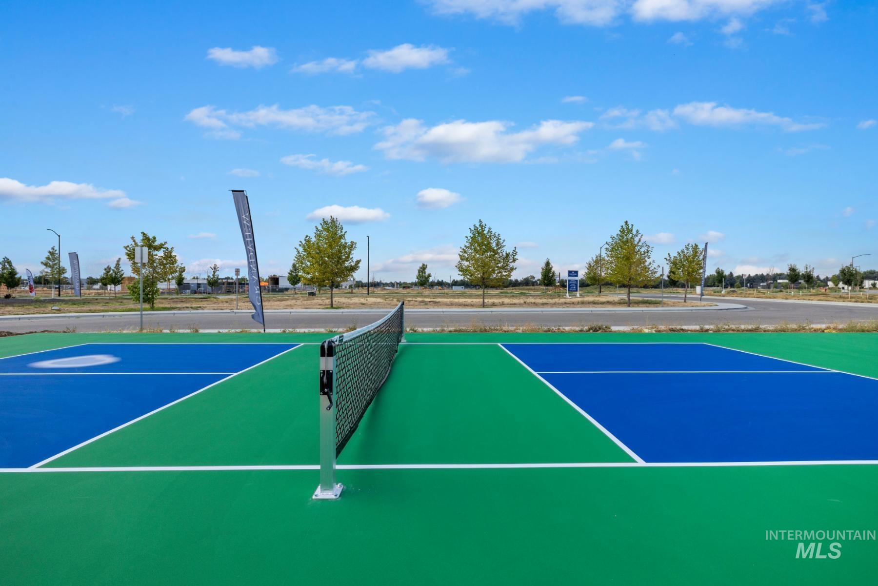 View of tennis court featuring community basketball court
