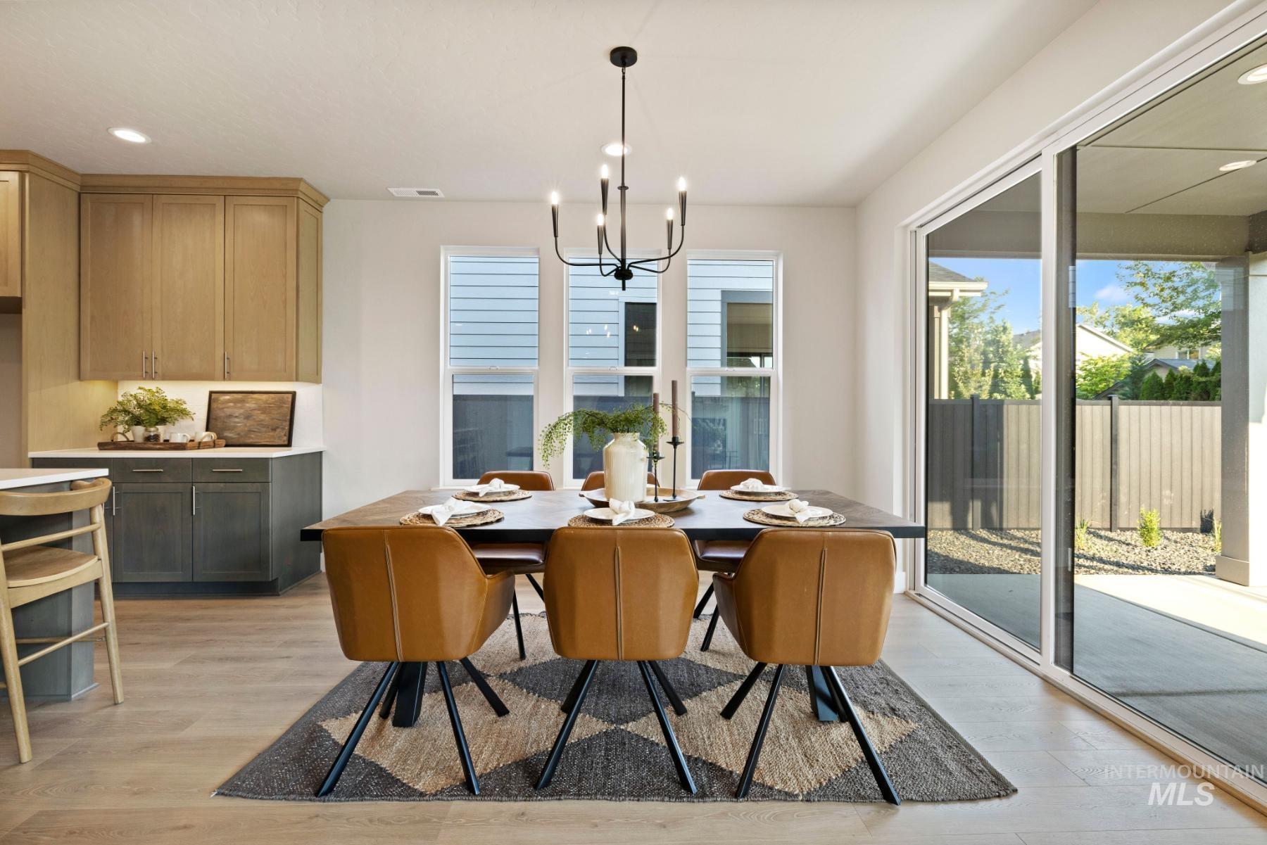 Dining area featuring recessed lighting, light wood-style floors, and a chandelier
