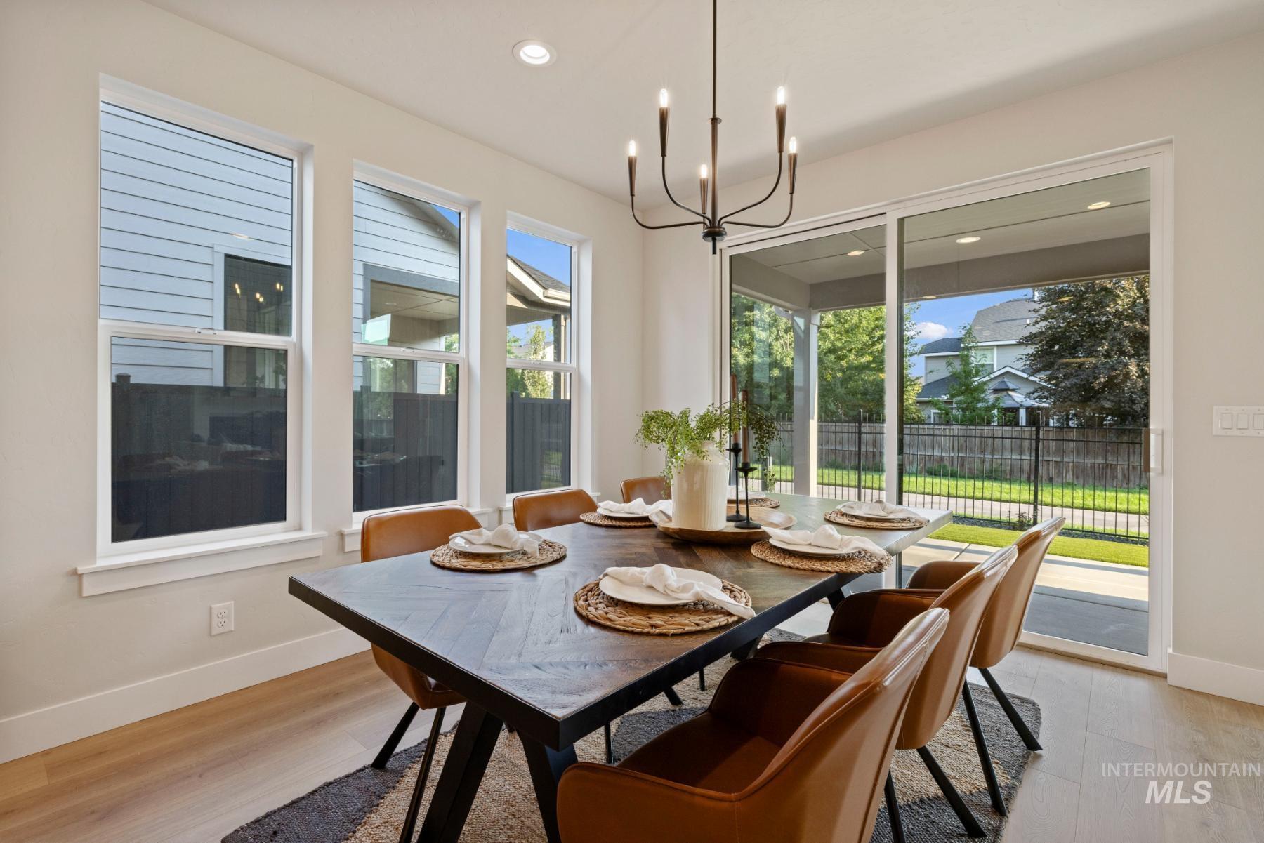 Dining space featuring light wood-style flooring, a chandelier, and recessed lighting
