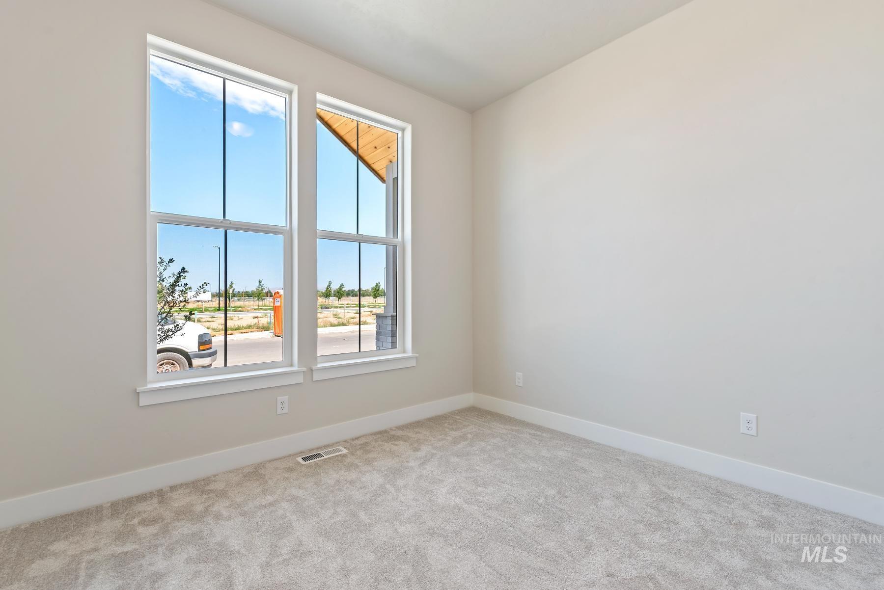 Empty room with baseboards and light carpet