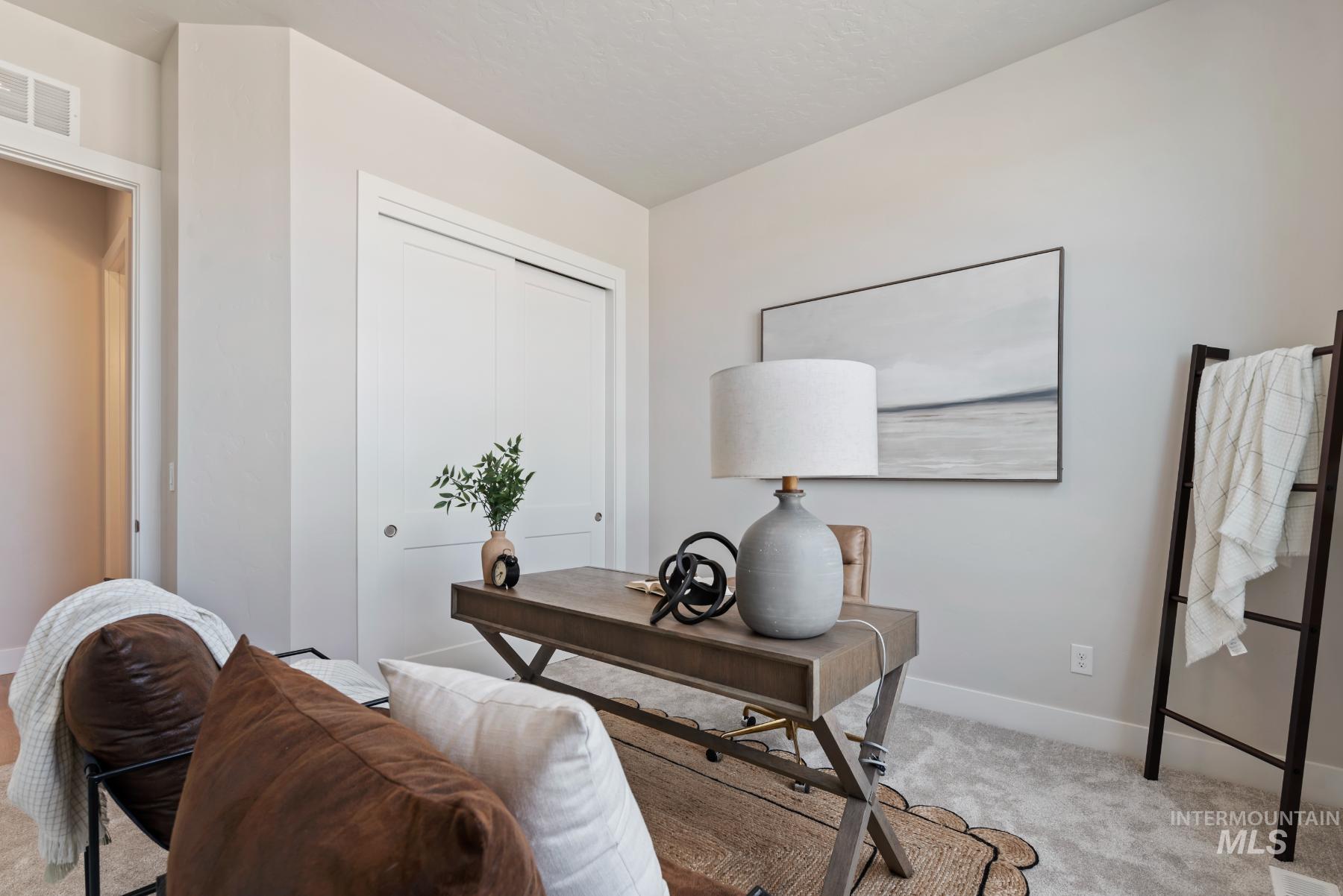 Carpeted home office with baseboards