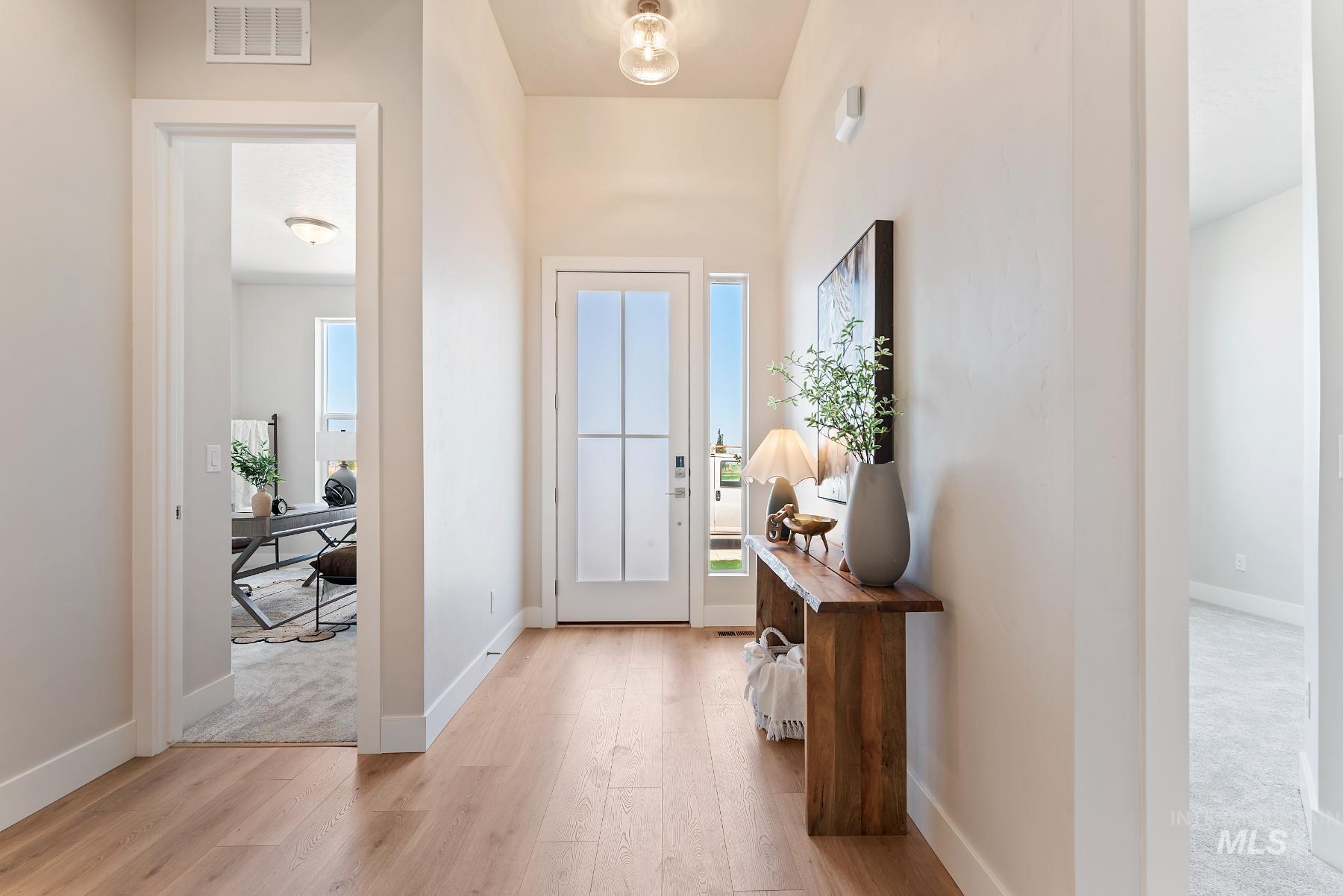 Entryway featuring wood finished floors and baseboards
