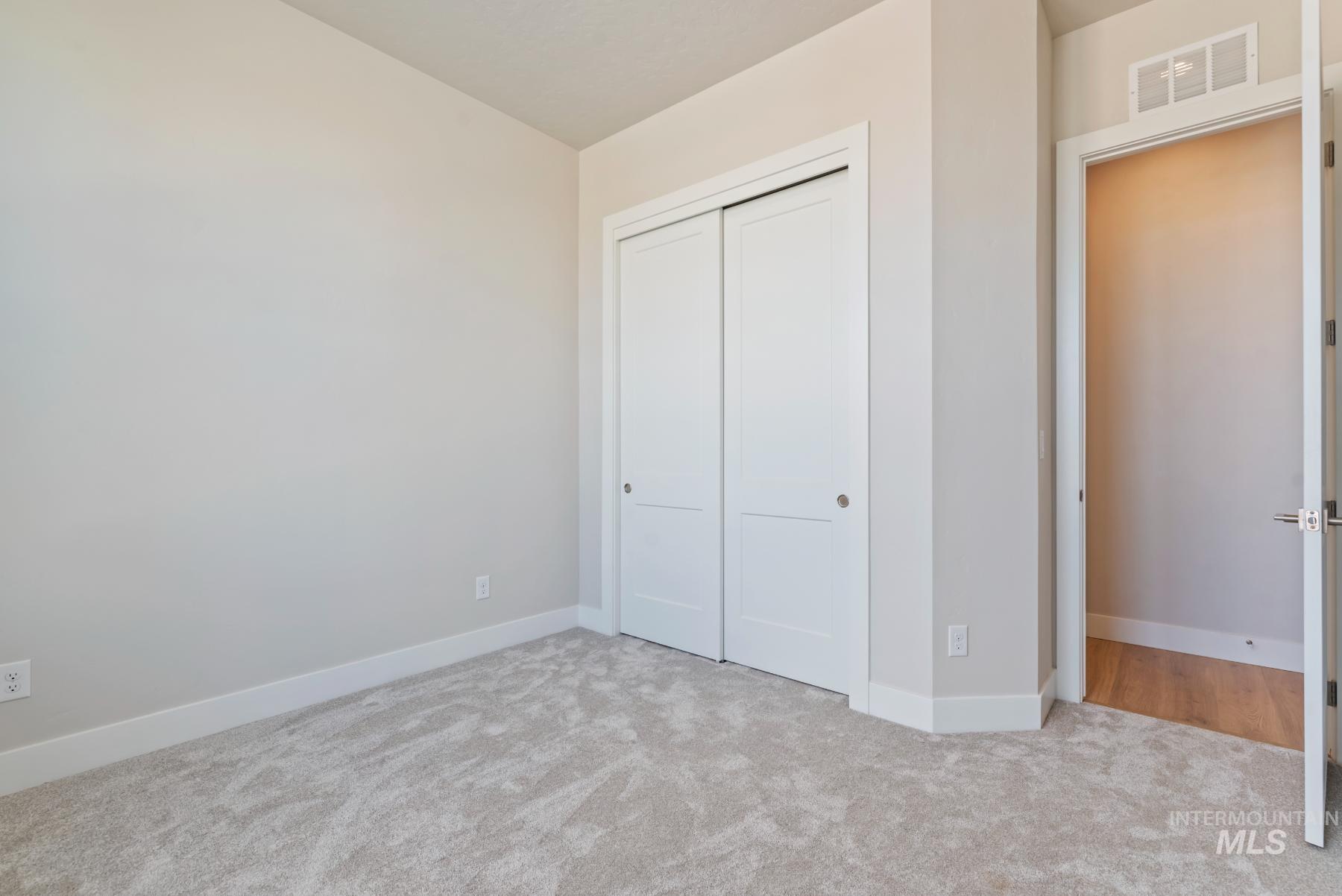 Unfurnished bedroom with a closet and carpet
