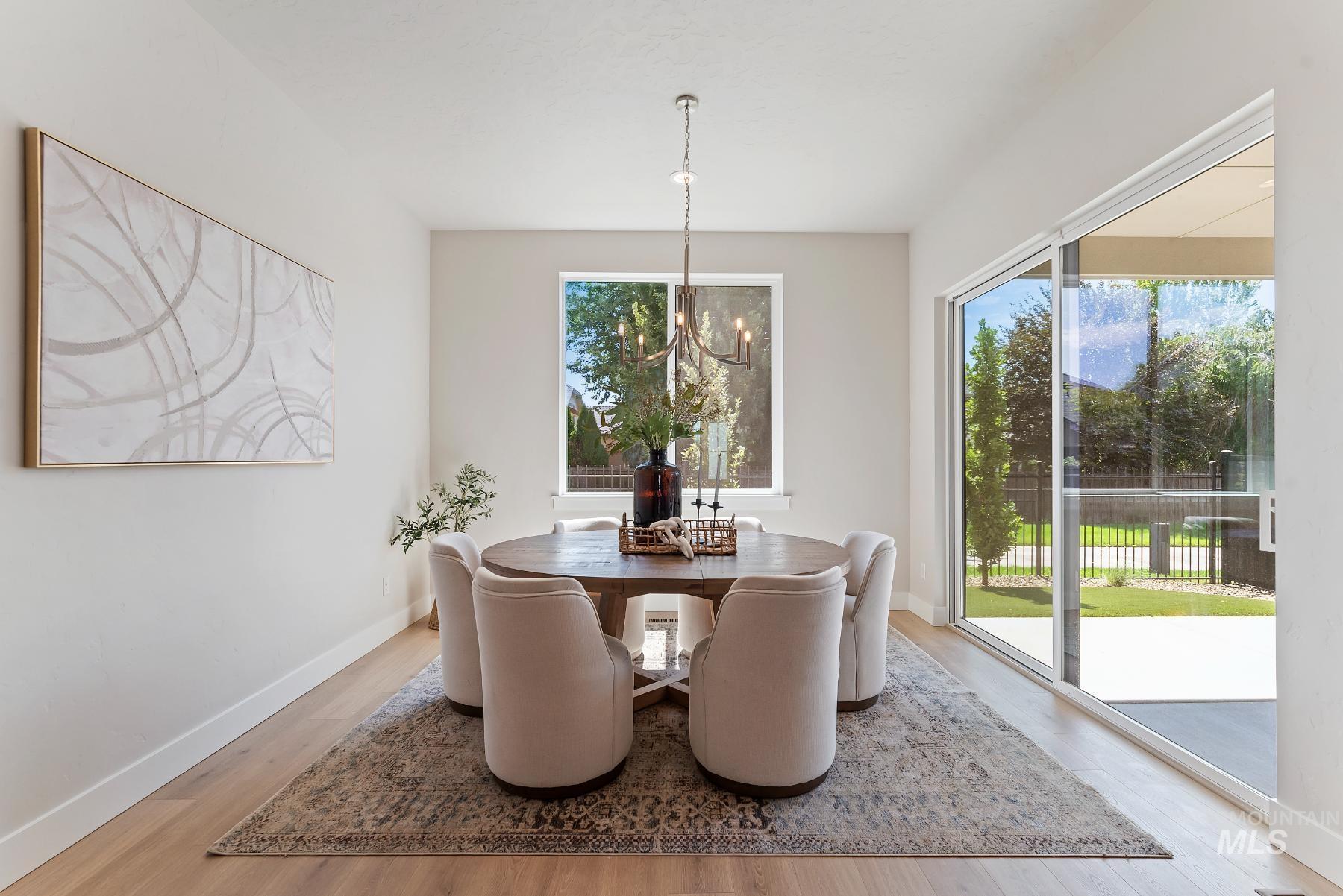 Dining room with a chandelier and light wood-style floors
