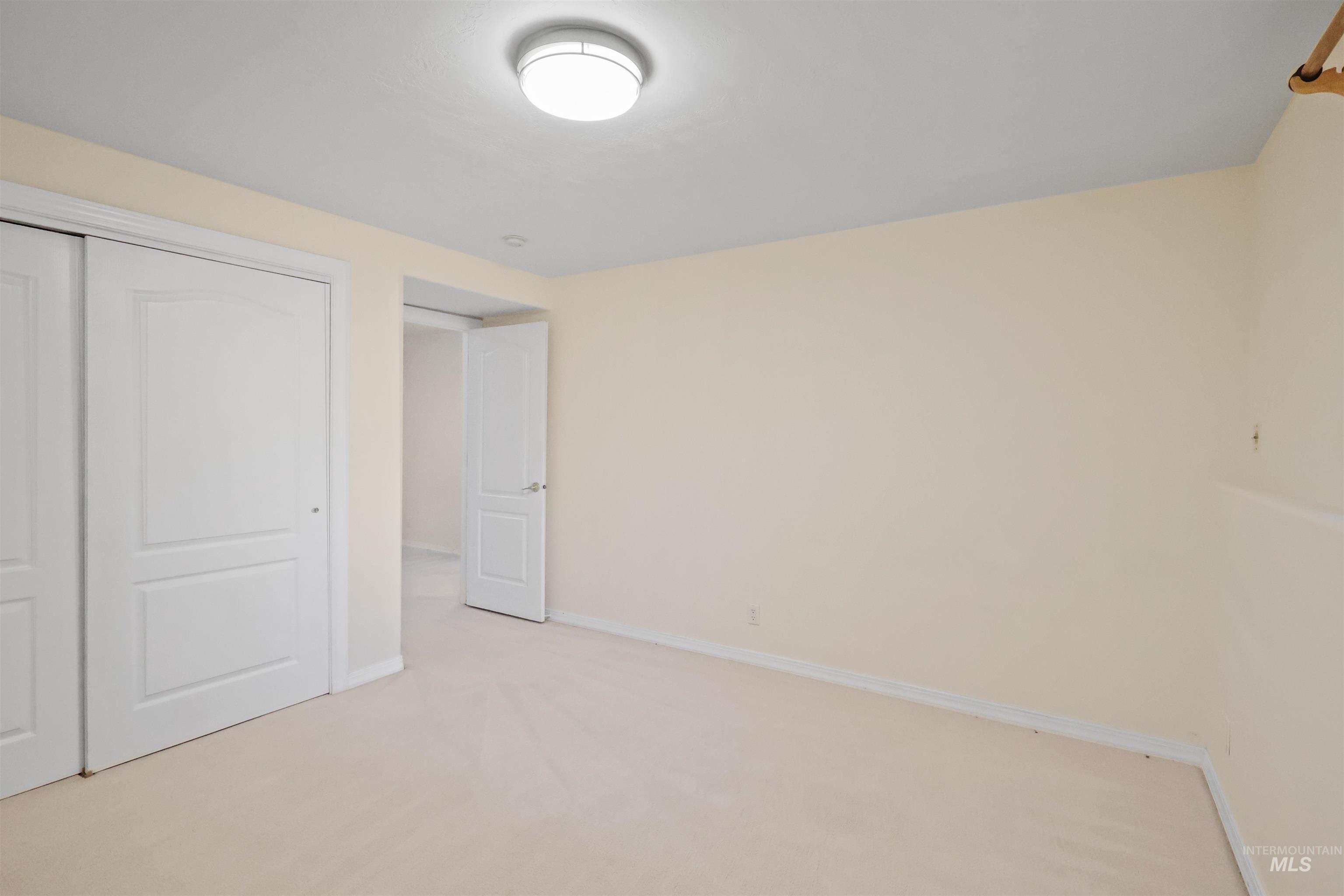 Unfurnished bedroom featuring carpet and a closet