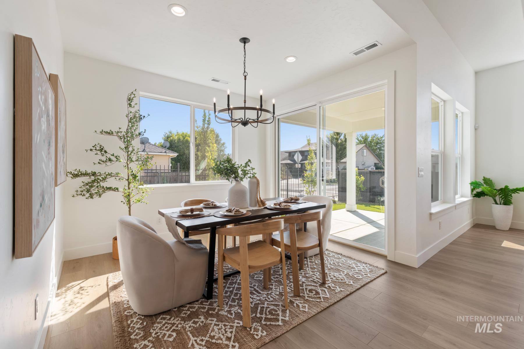 Dining space featuring light wood-style floors, a chandelier, and recessed lighting