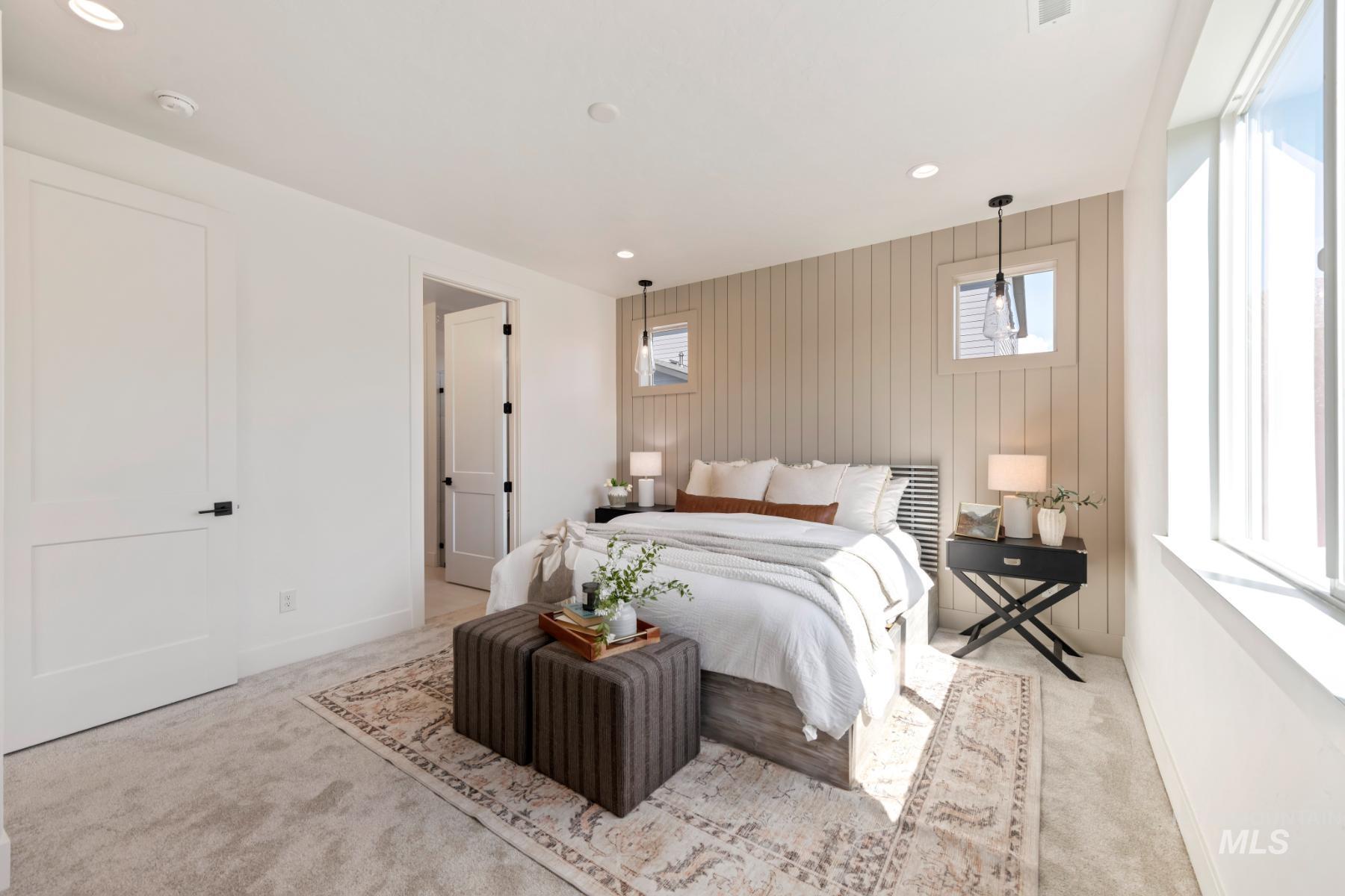Bedroom with multiple windows, light carpet, recessed lighting, and wood walls
