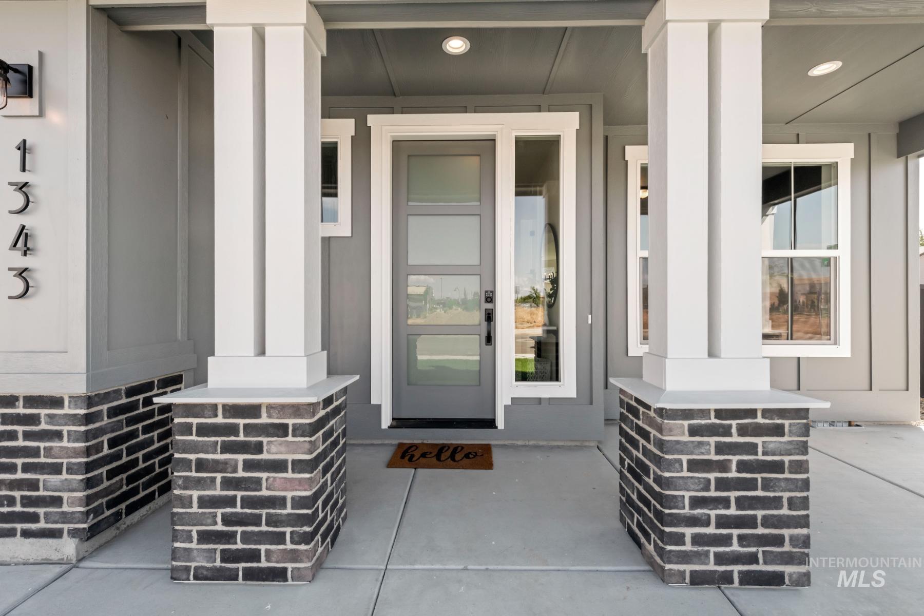 View of exterior entry with covered porch