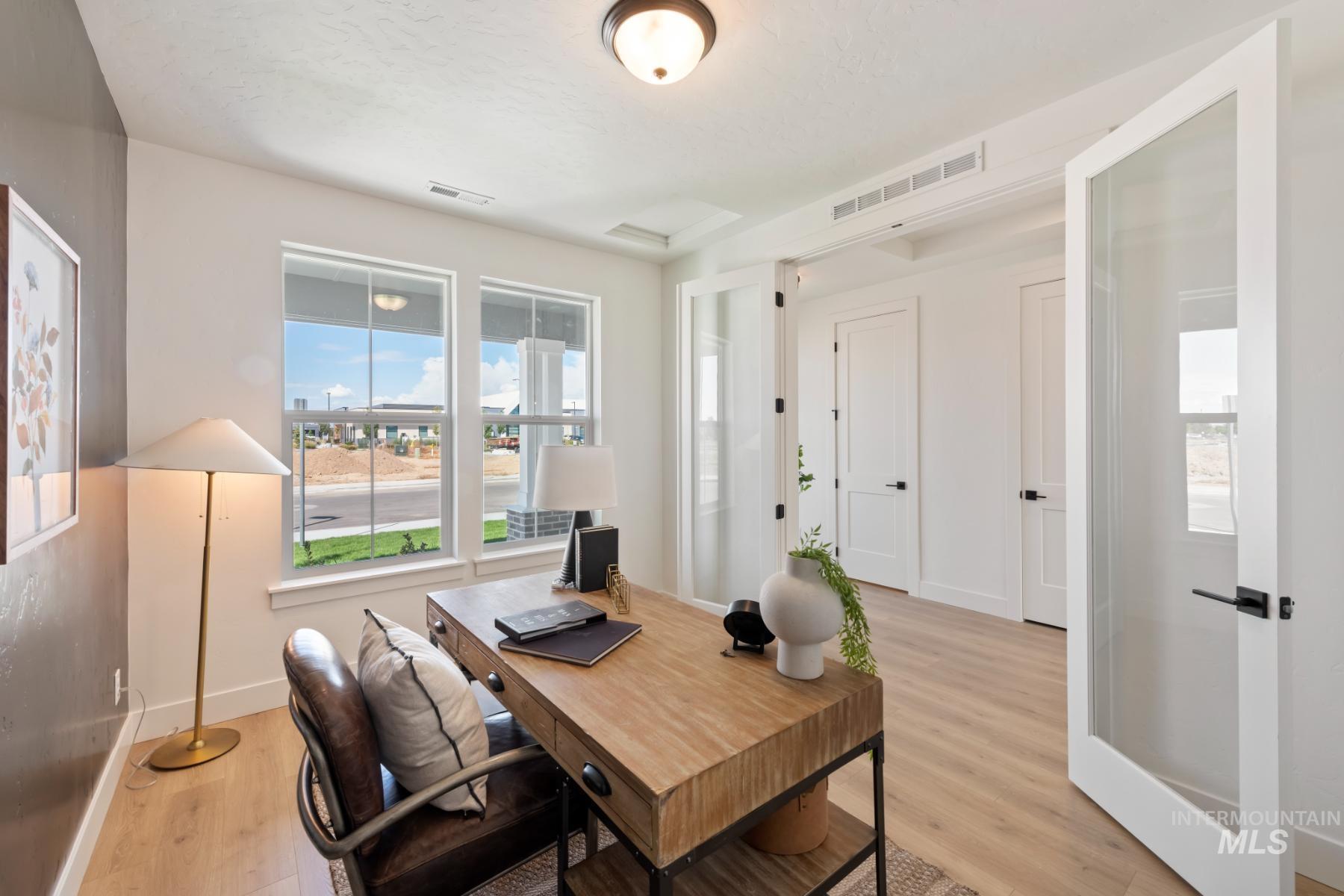 Home office featuring plenty of natural light and light wood-type flooring