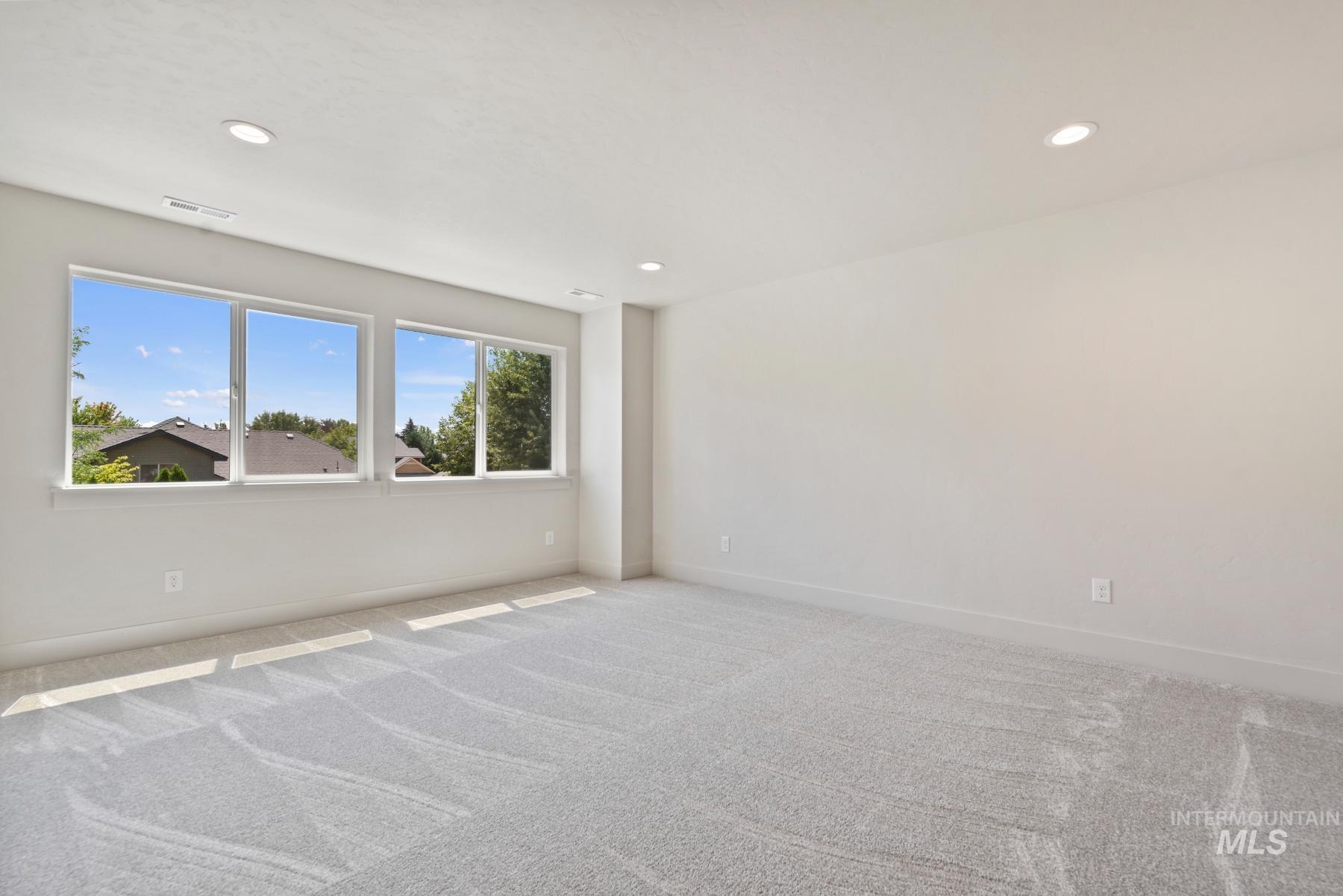 Unfurnished room with carpet and recessed lighting