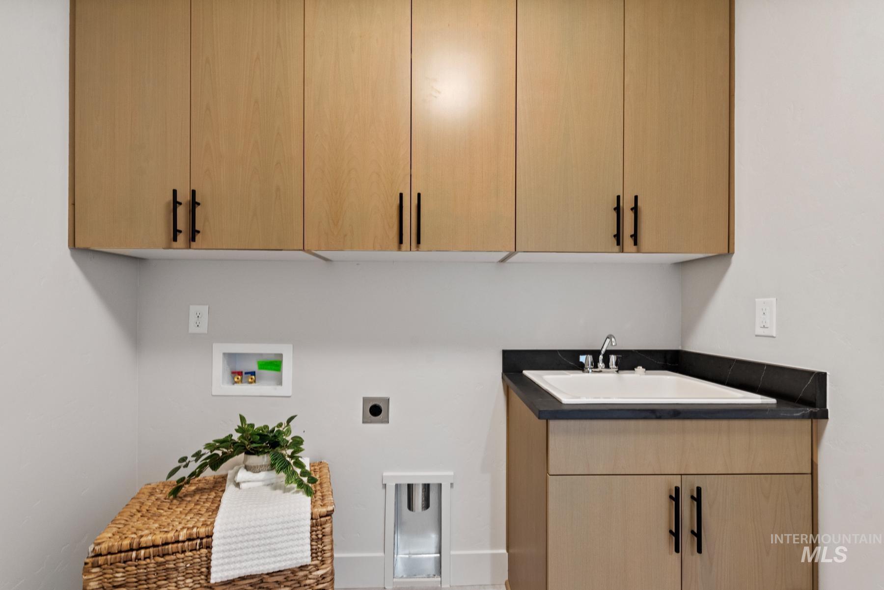 Washroom featuring washer hookup, cabinet space, and hookup for an electric dryer
