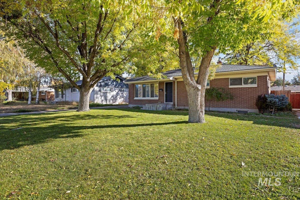 Ranch-style house with brick siding and a front lawn