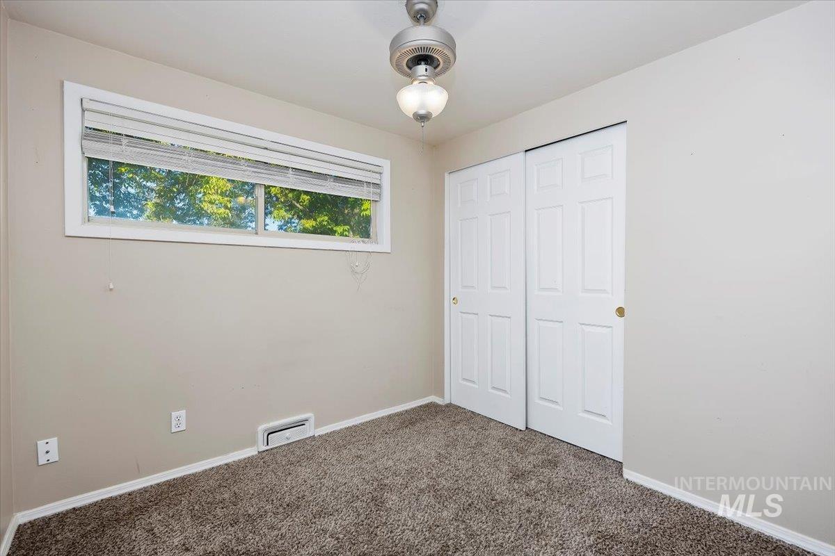 Unfurnished bedroom featuring carpet flooring and a closet