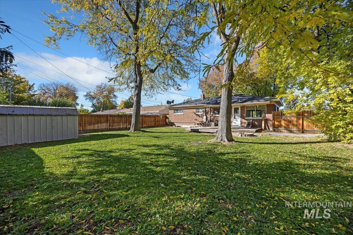 Fenced backyard with a storage shed