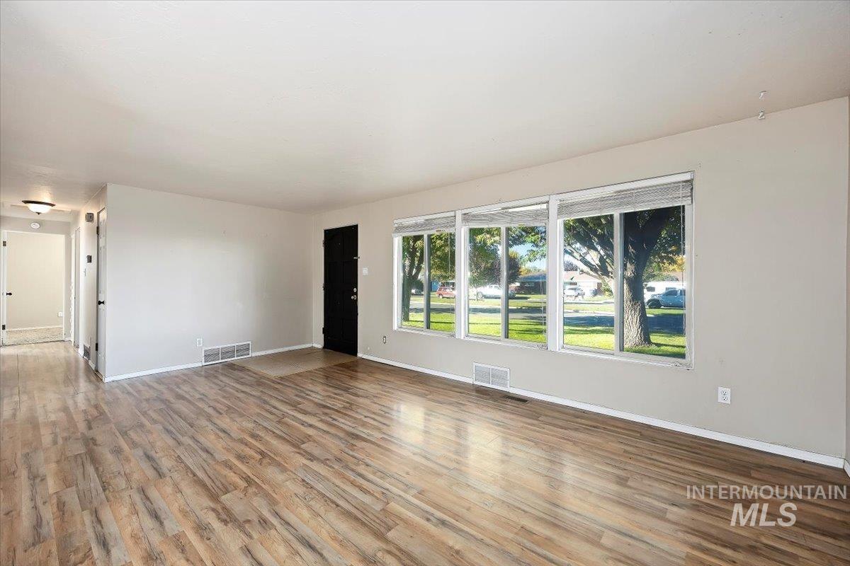 Spare room featuring wood finished floors and baseboards
