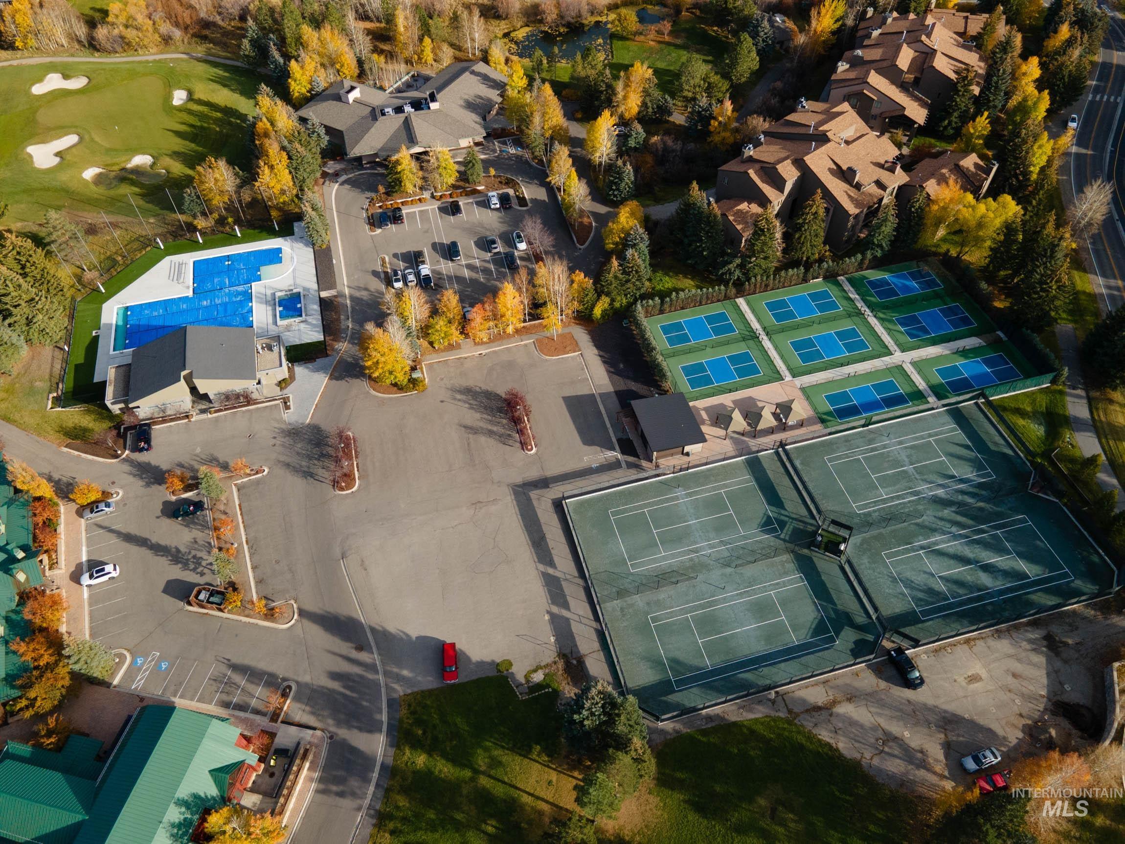 Aerial overview of property's location with a pool and a golf club