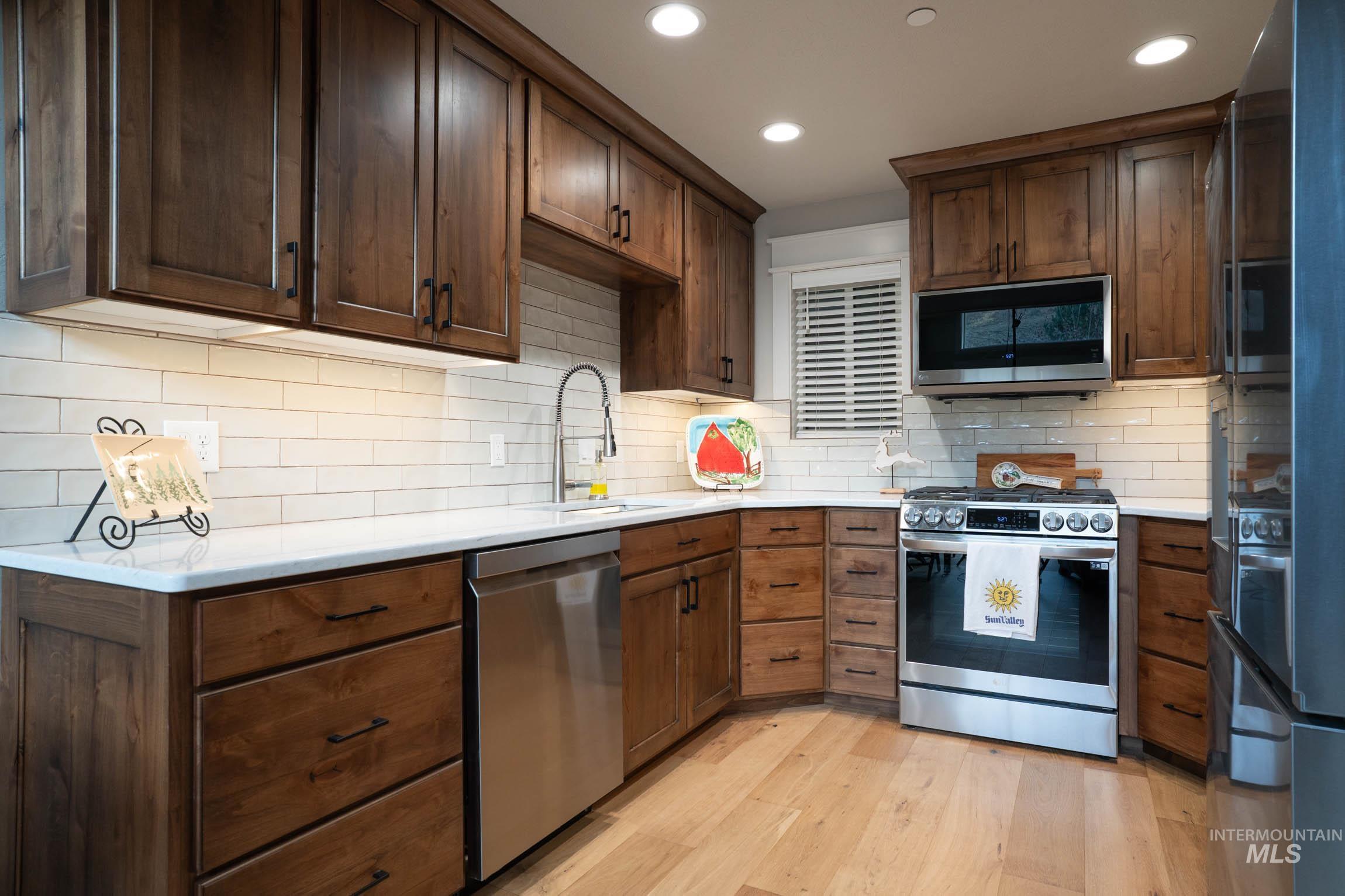 Custom cabinets, quartz countertops, stainless steel appliances