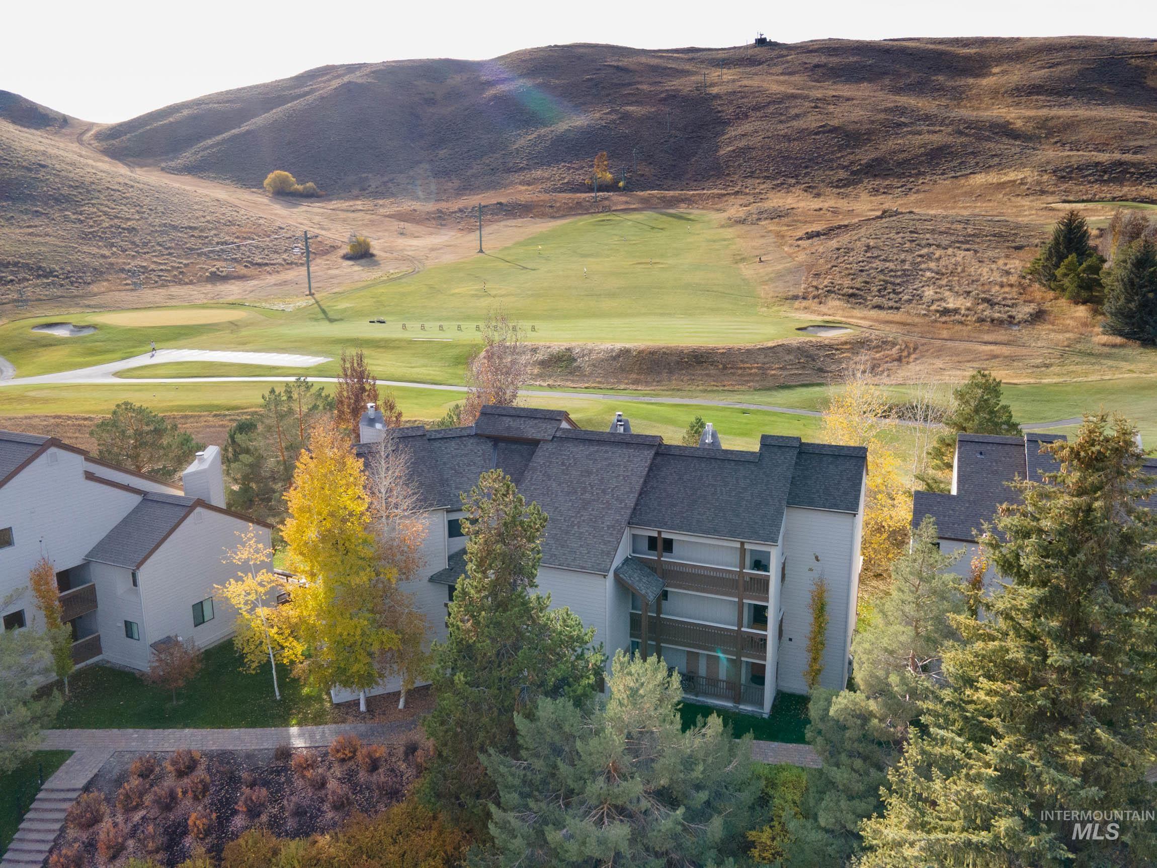 Aerial view of a mountainous background and a golf course