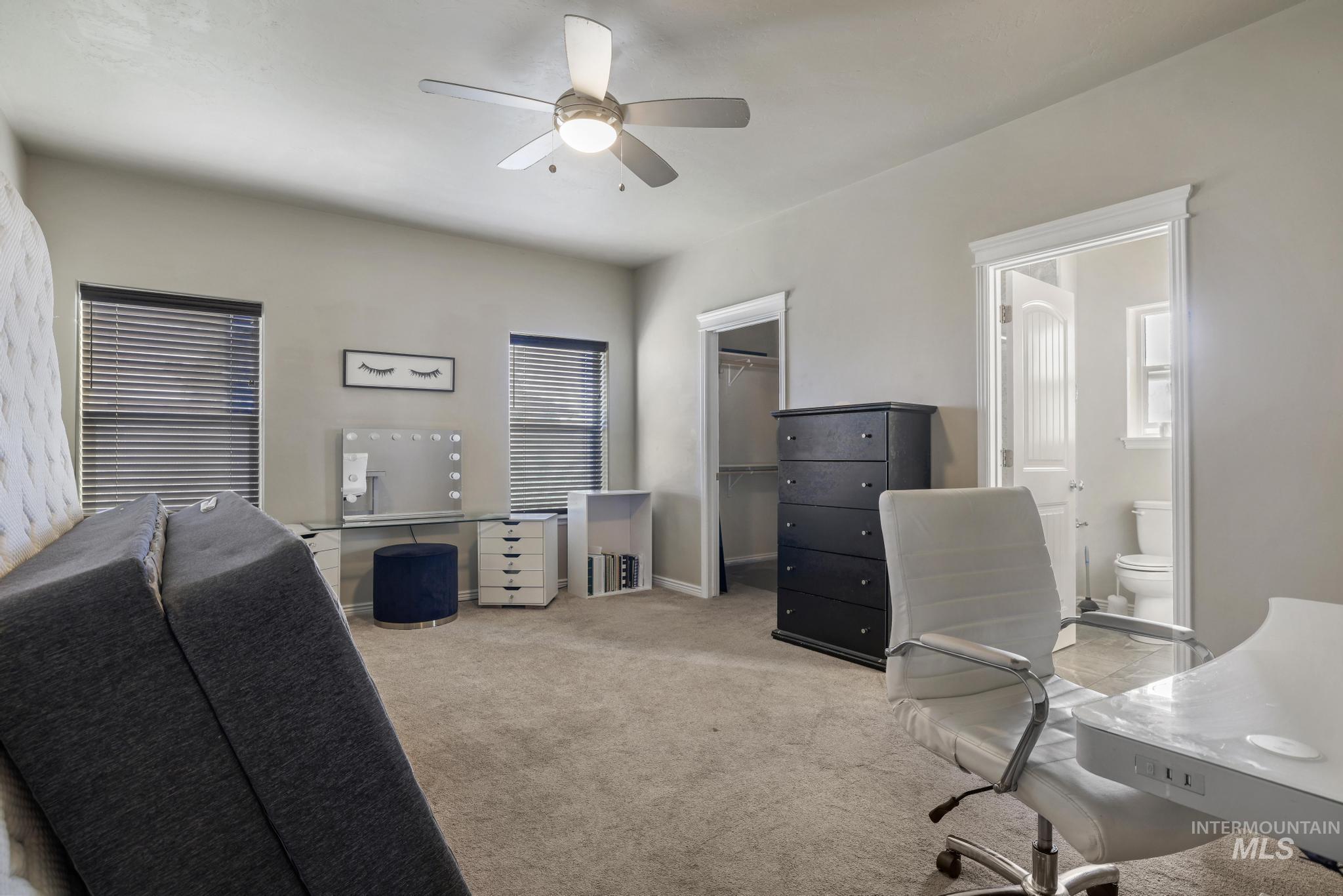 Office space with carpet flooring and ceiling fan