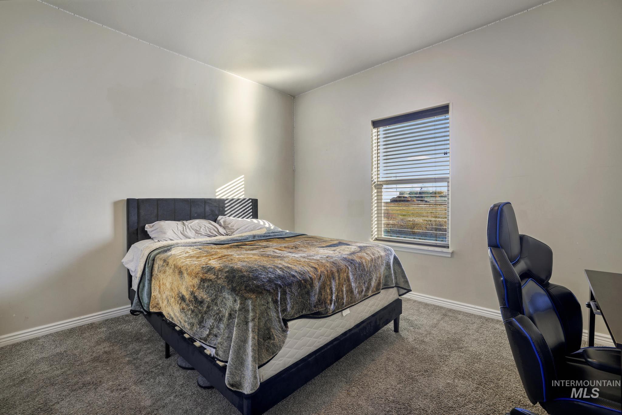 Carpeted bedroom with baseboards