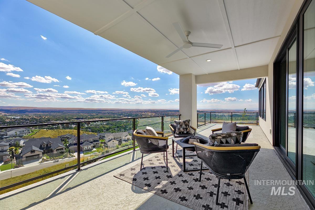 Balcony with ceiling fan, an outdoor hangout area, and a residential view