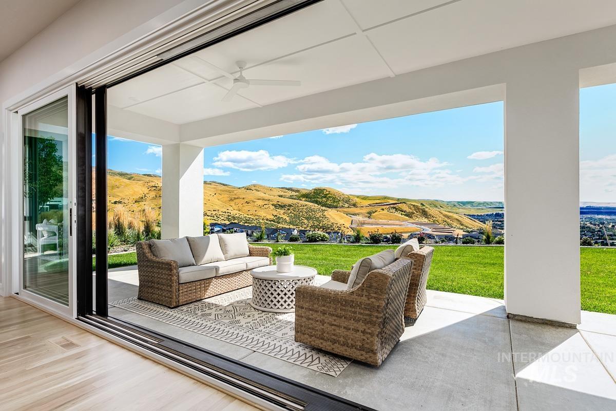 View of patio / terrace with an outdoor living space, ceiling fan, and a mountain view