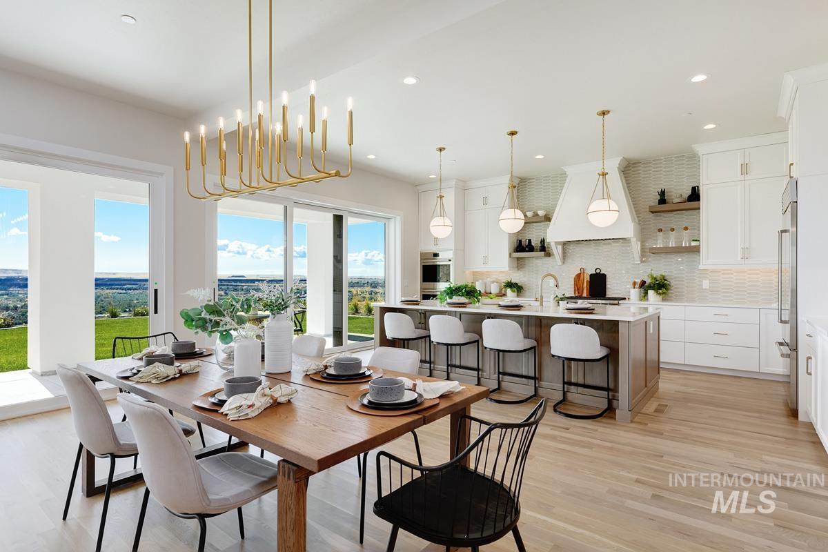 Dining space with light wood finished floors, recessed lighting, and a chandelier