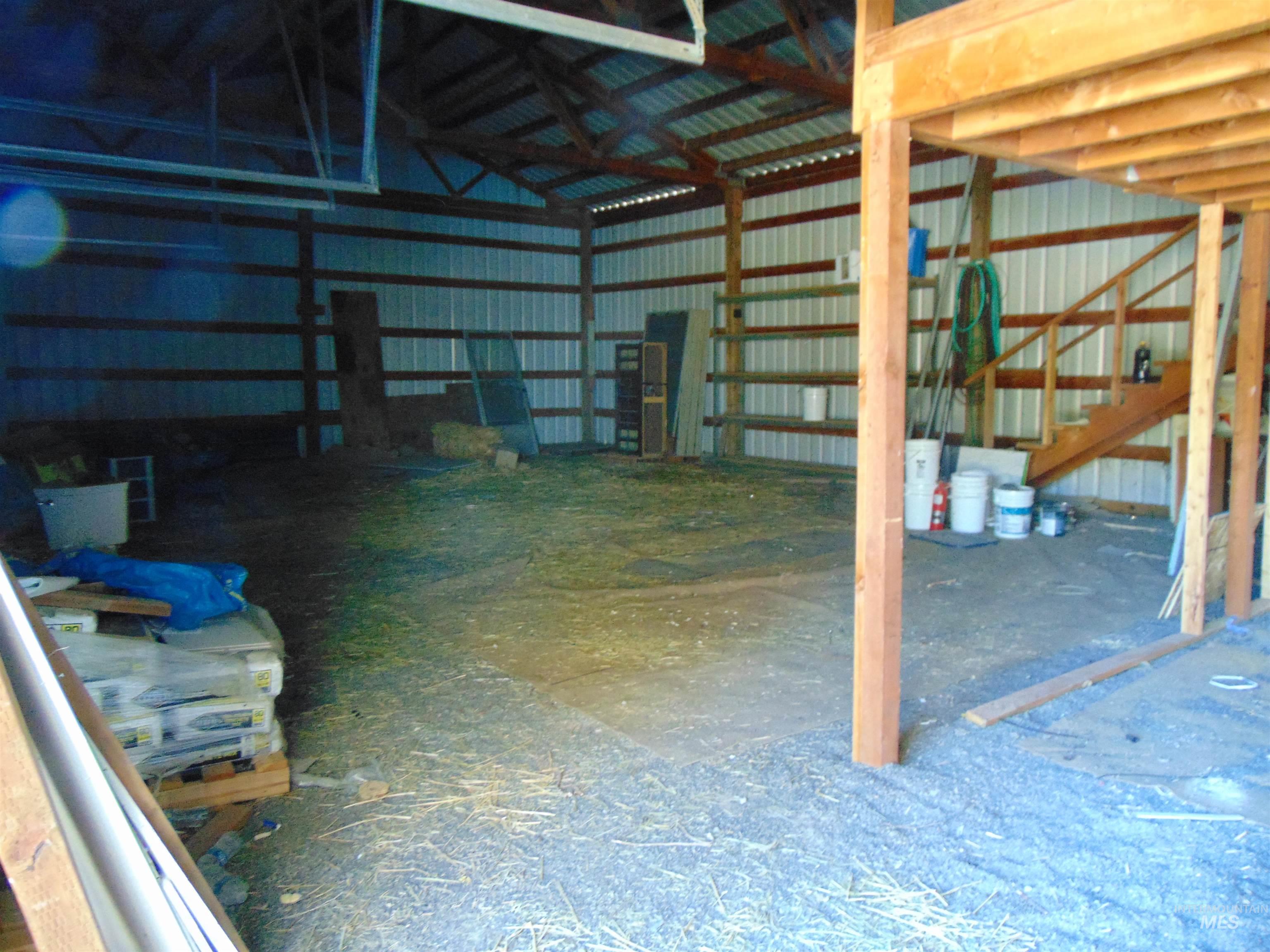 Misc room featuring metal wall and vaulted ceiling
