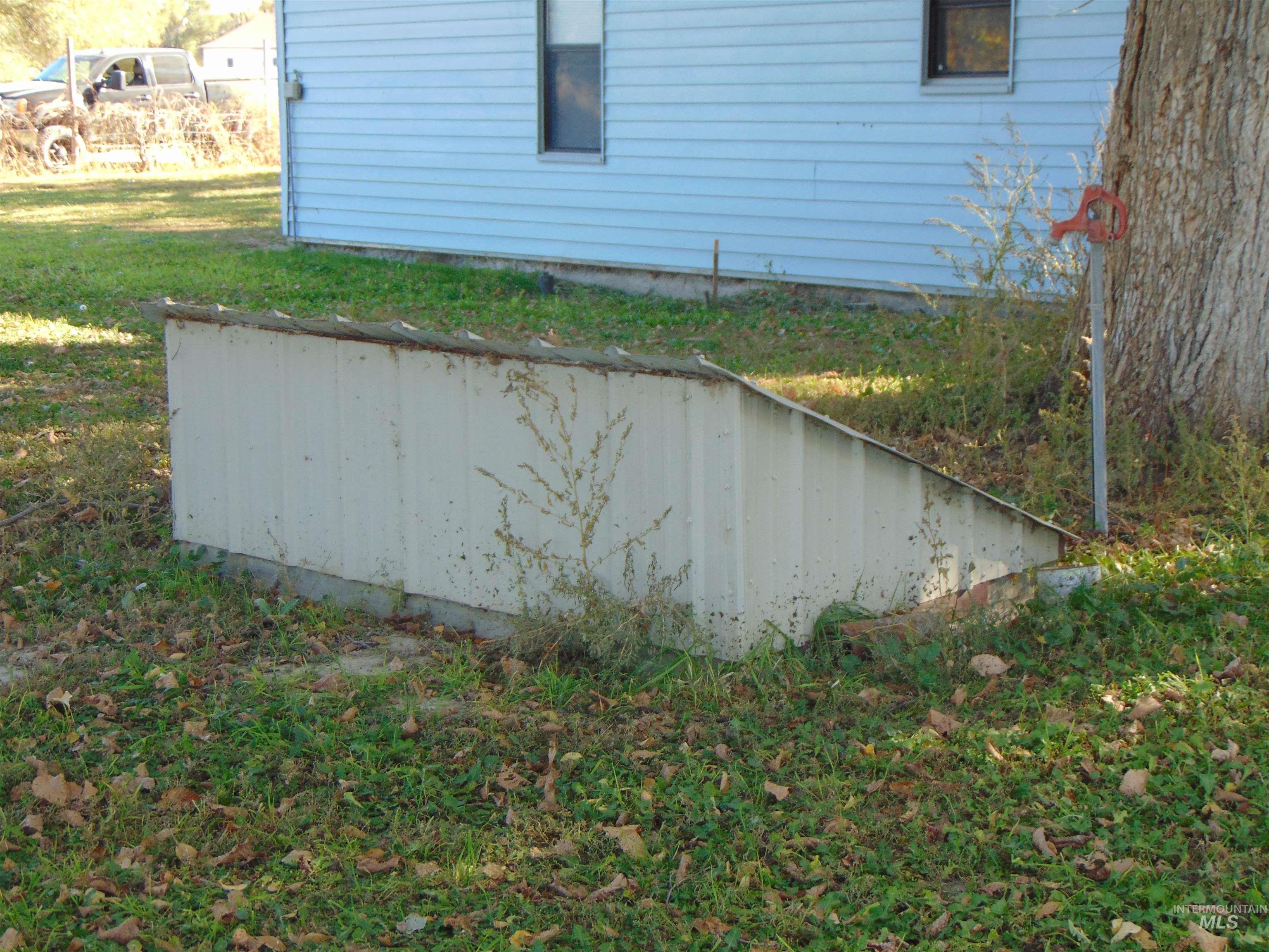 View of property exterior featuring a lawn