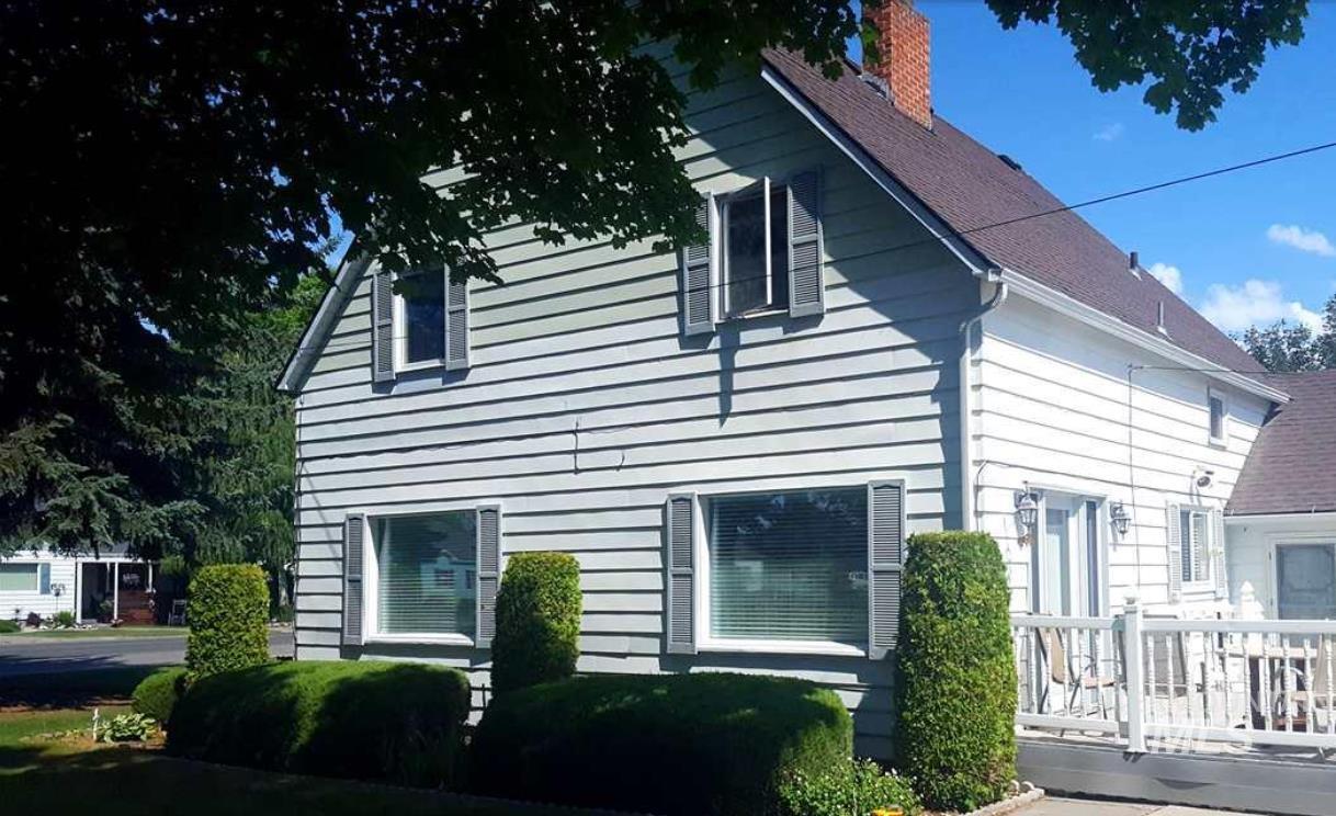 View of side of home with a deck and a chimney