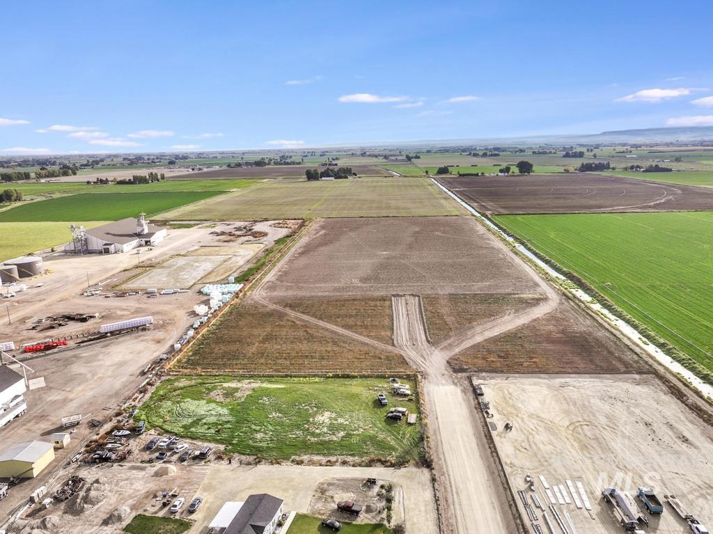 Overview of rural landscape featuring large plots for crops