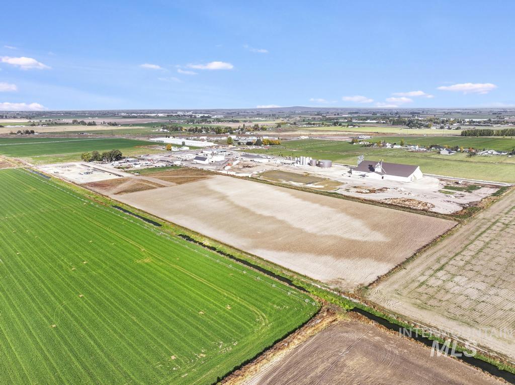 Aerial view of sparsely populated area featuring rows of crops