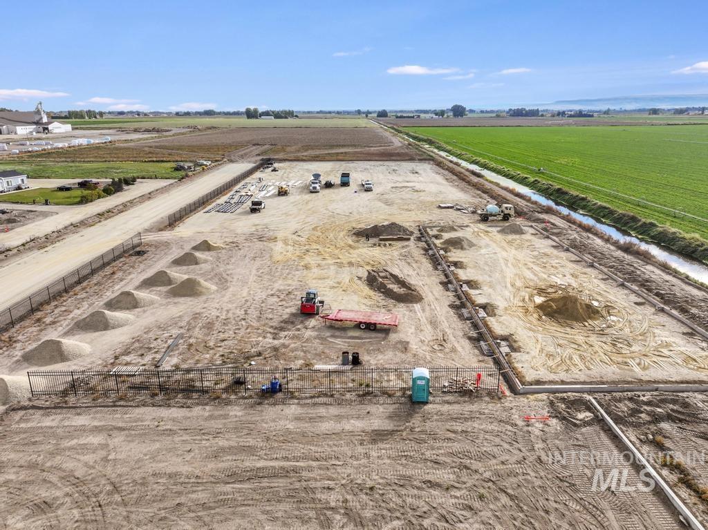 Aerial view of sparsely populated area with rows of crops