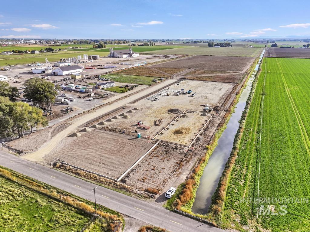 Overview of rural landscape with large plots for crops and a large body of water