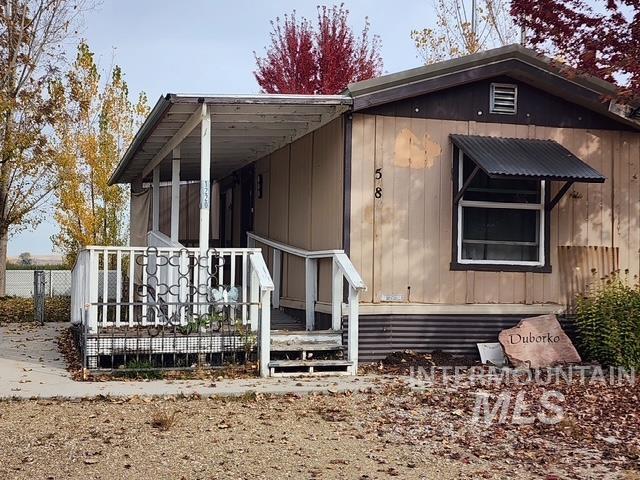 View of side of home featuring a wooden deck