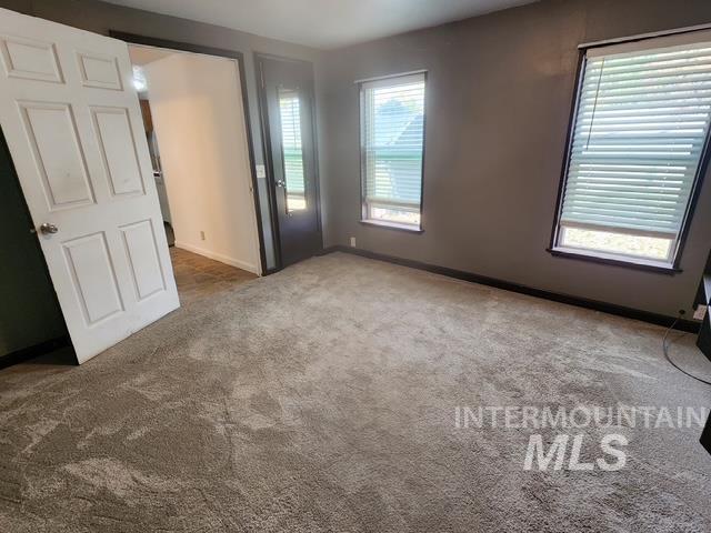 Spare room with carpet flooring and baseboards