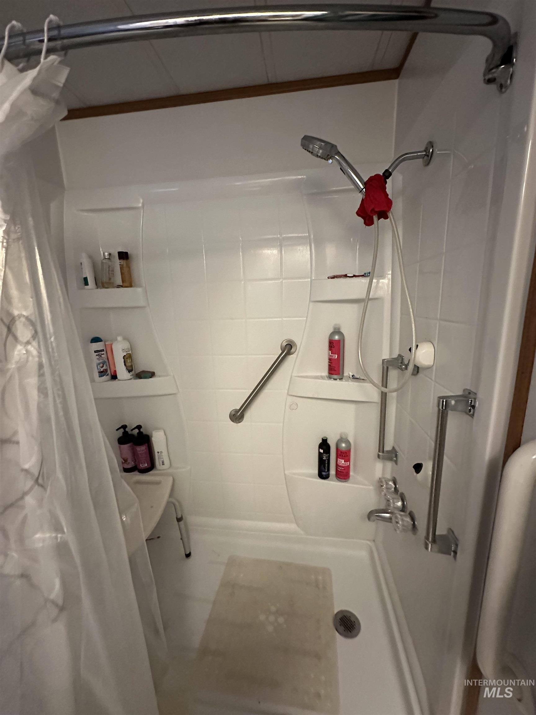 Bathroom with a shower with shower curtain