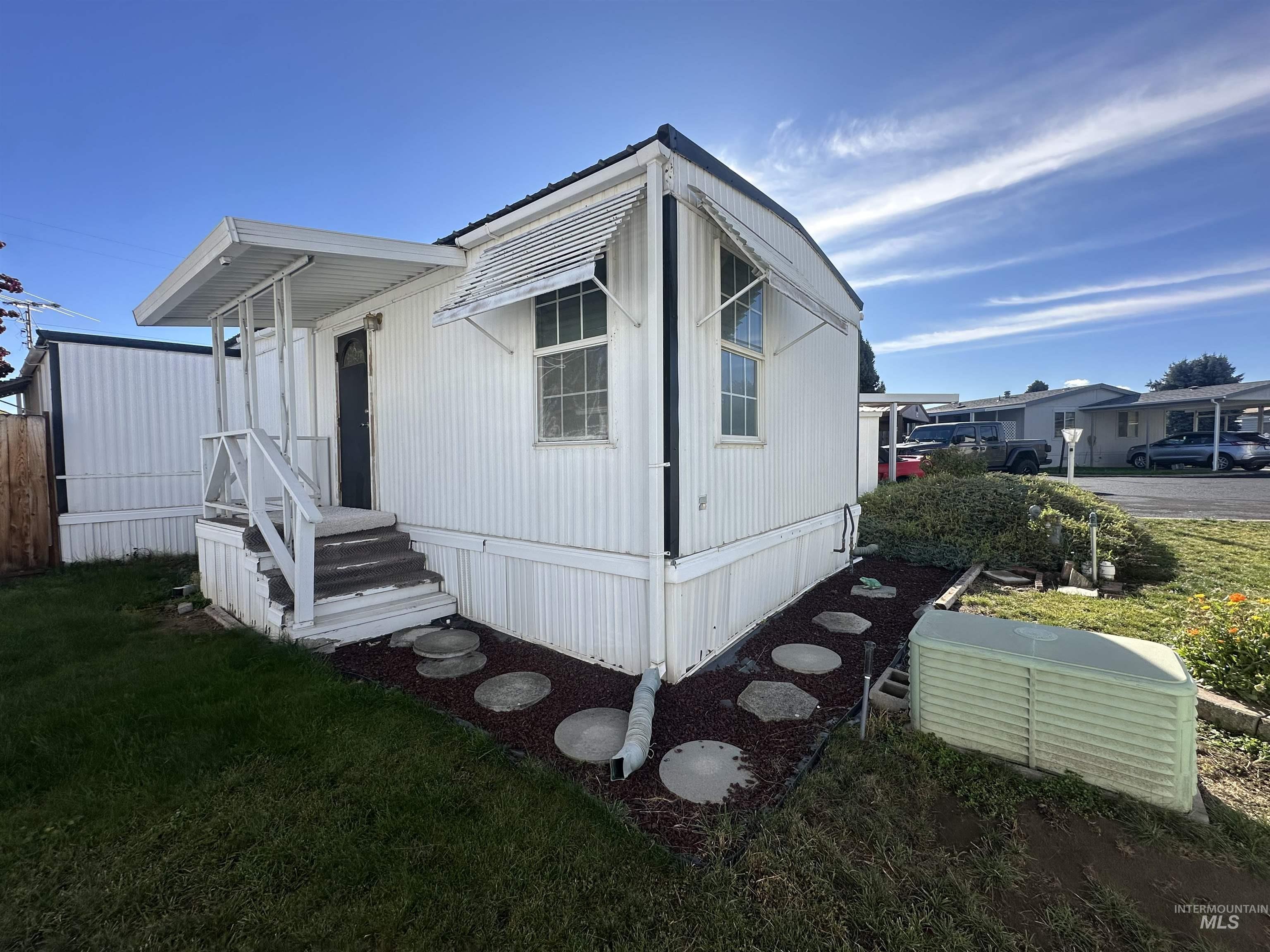 View of side of property featuring a yard