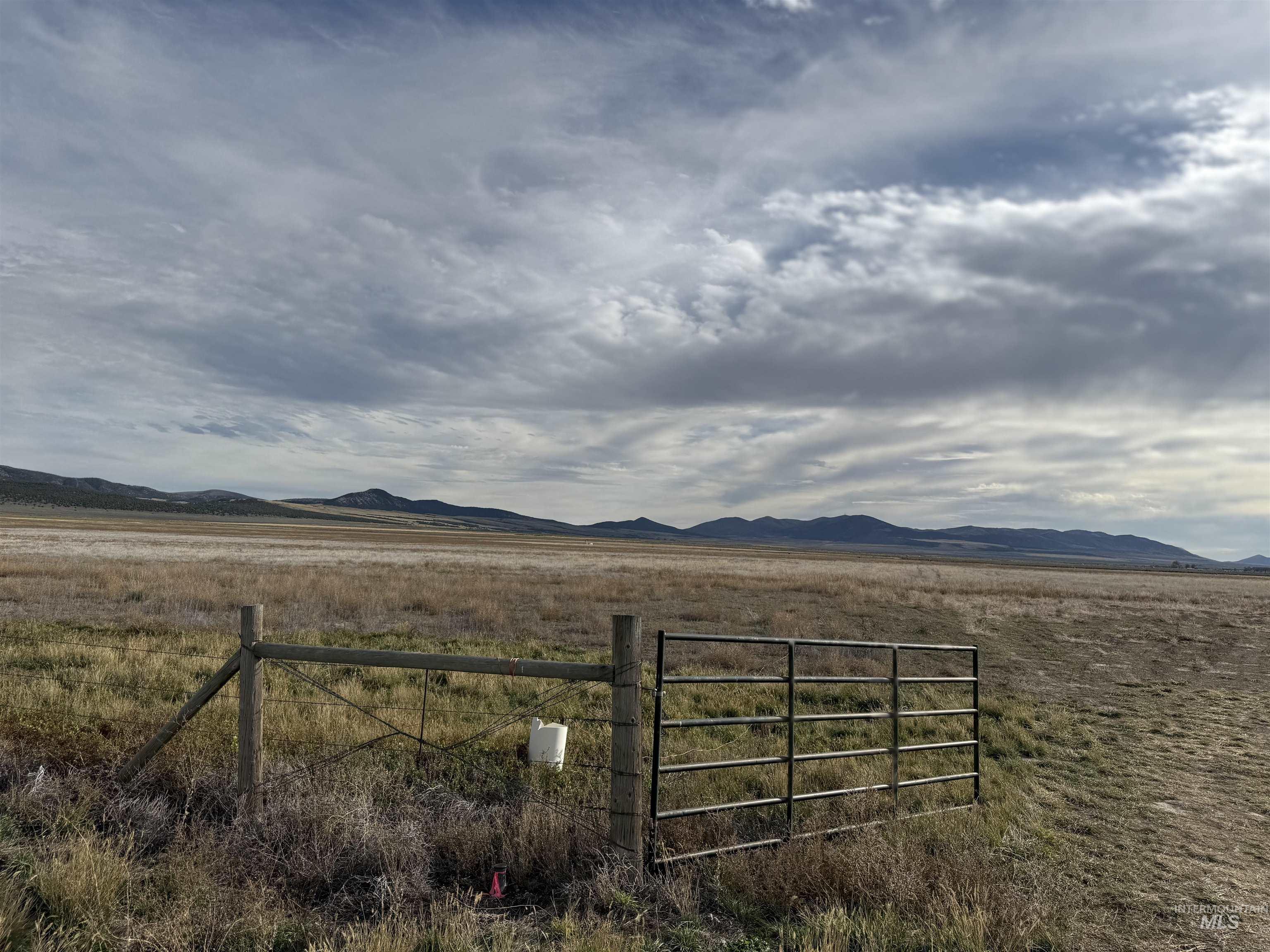 View of mountain backdrop with rural landscape